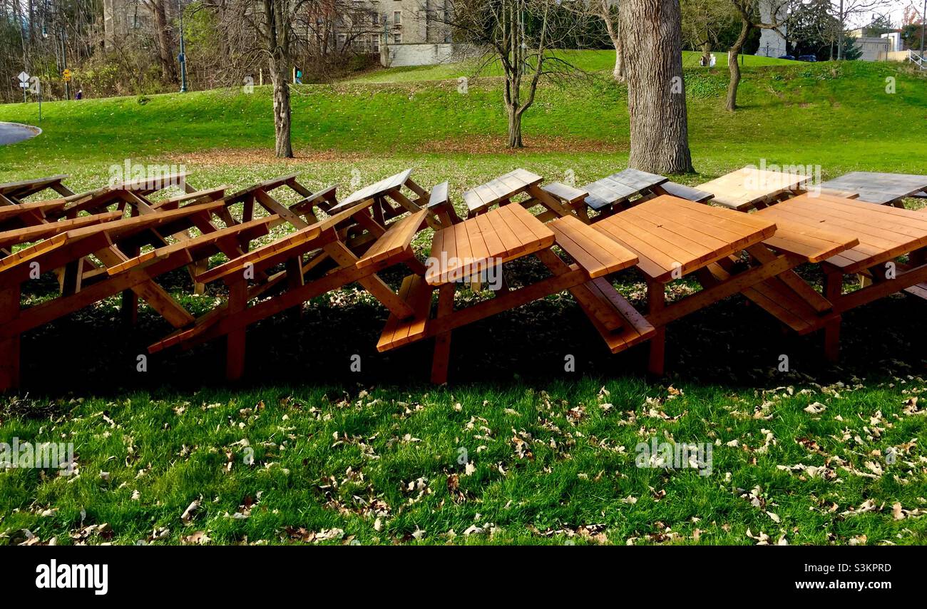 Picnic tables stacked in an outdoor green space, Ontario, Canada. - Smartphone Captured Stock Image