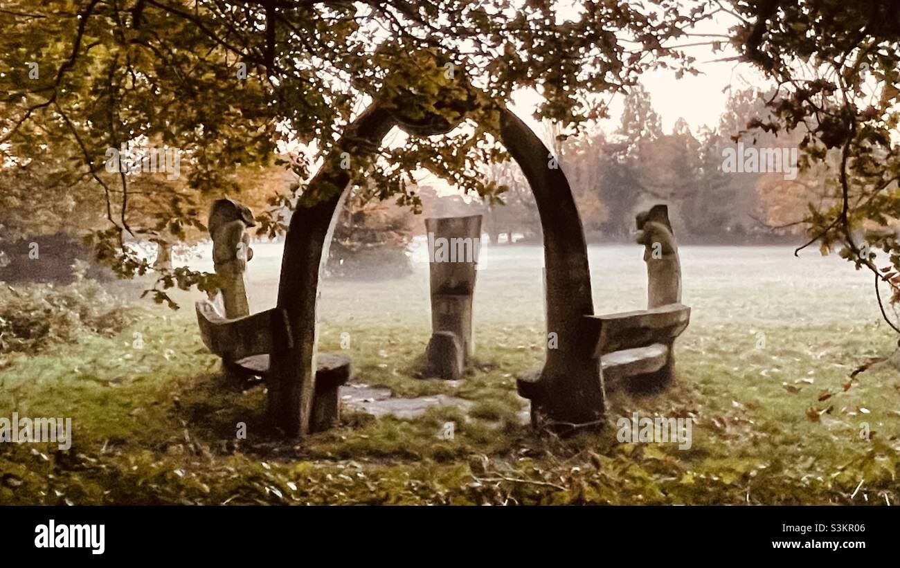 Storytelling bench in a park in the mist Stock Photo