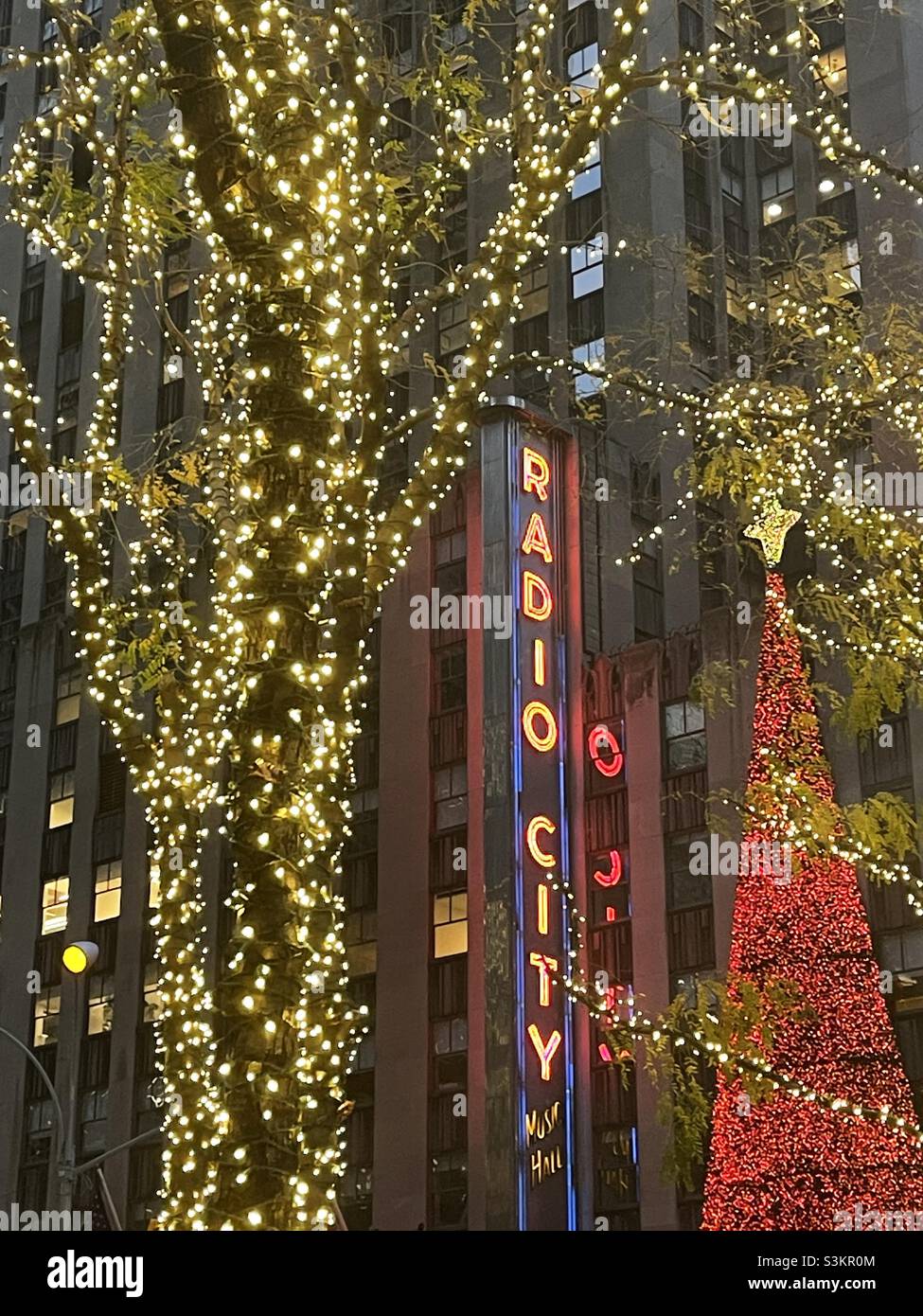 Radio city music Hall is brightly lit during the holiday season in Midtown Manhattan, Rockefeller center, 2021, United States, New York City - Smartphone Captured Stock Image