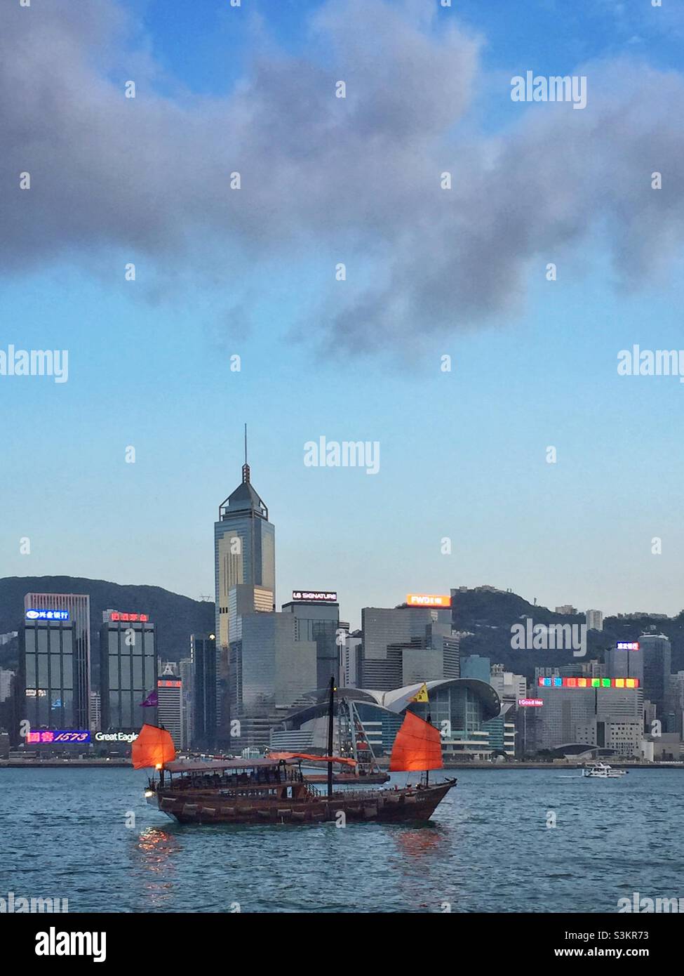 The Aqualuna II, a replica Chinese junk, carries tourists for pleasure cruises, Victoria Harbour, Hong Kong - Smartphone Captured Stock Image
