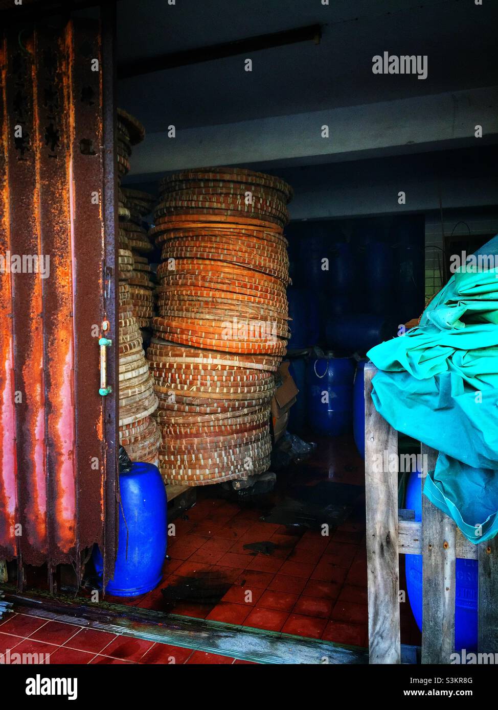 Drying baskets and storage drums in a shrimp paste factory, Tai O, Lantau Island, Hong Kong - Smartphone Captured Stock Image