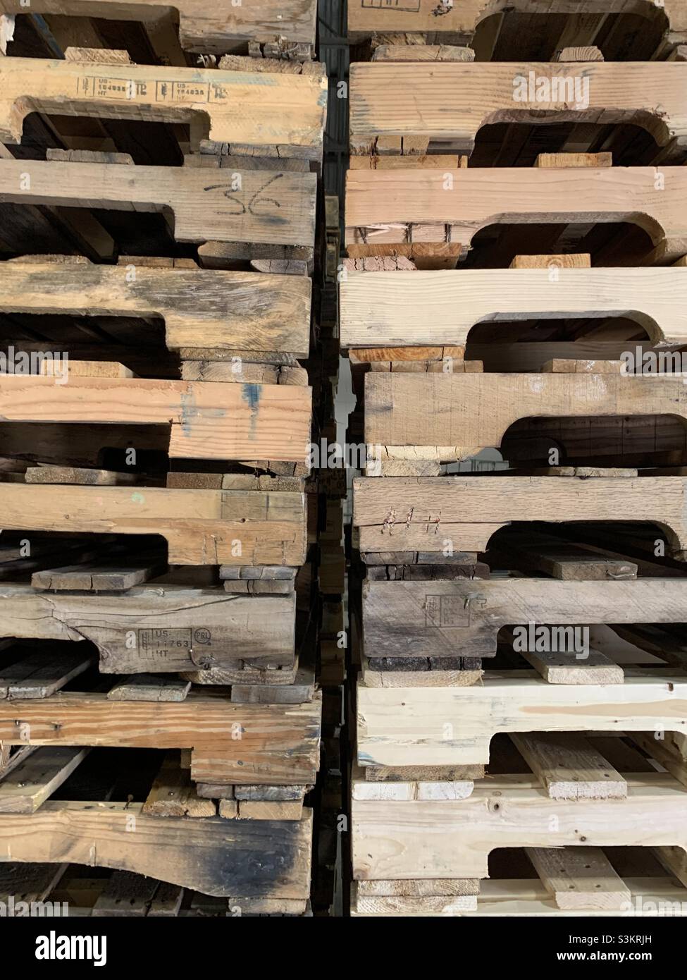 Two tall stacks of wooden pallets side by side on a warehouse dock in Utah, USA. - Smartphone Captured Stock Image