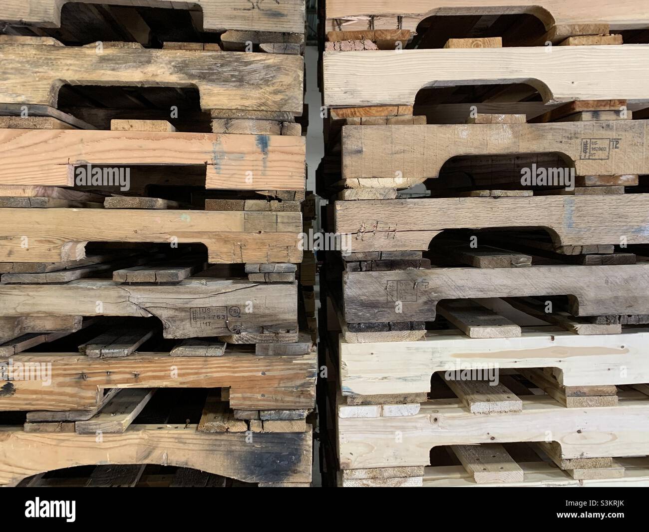Two tall stacks of wooden pallets side by side on a warehouse dock in Utah, USA. - Smartphone Captured Stock Image