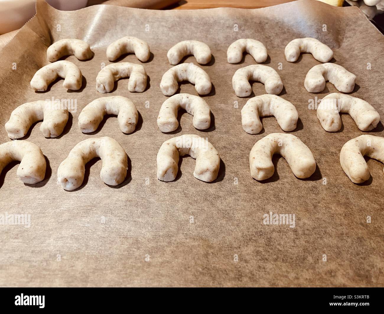Beautiful snow croissant cookies placed on a baking plate - Smartphone Captured Stock Image