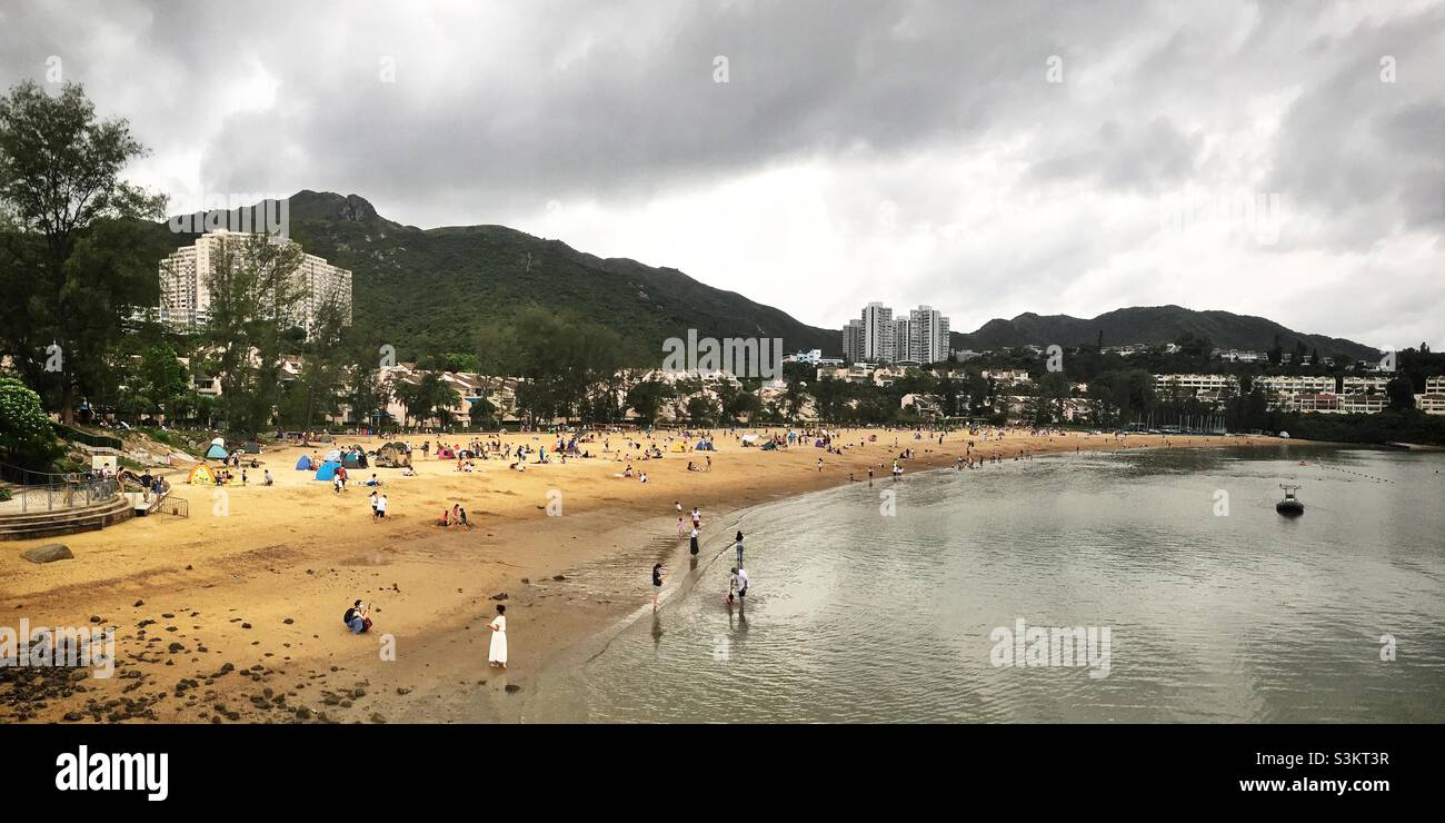 Domestic tourists visit Discovery Bay's man-made Tai Pak Beach, Lantau Island, Hong Kong - Smartphone Captured Stock Image