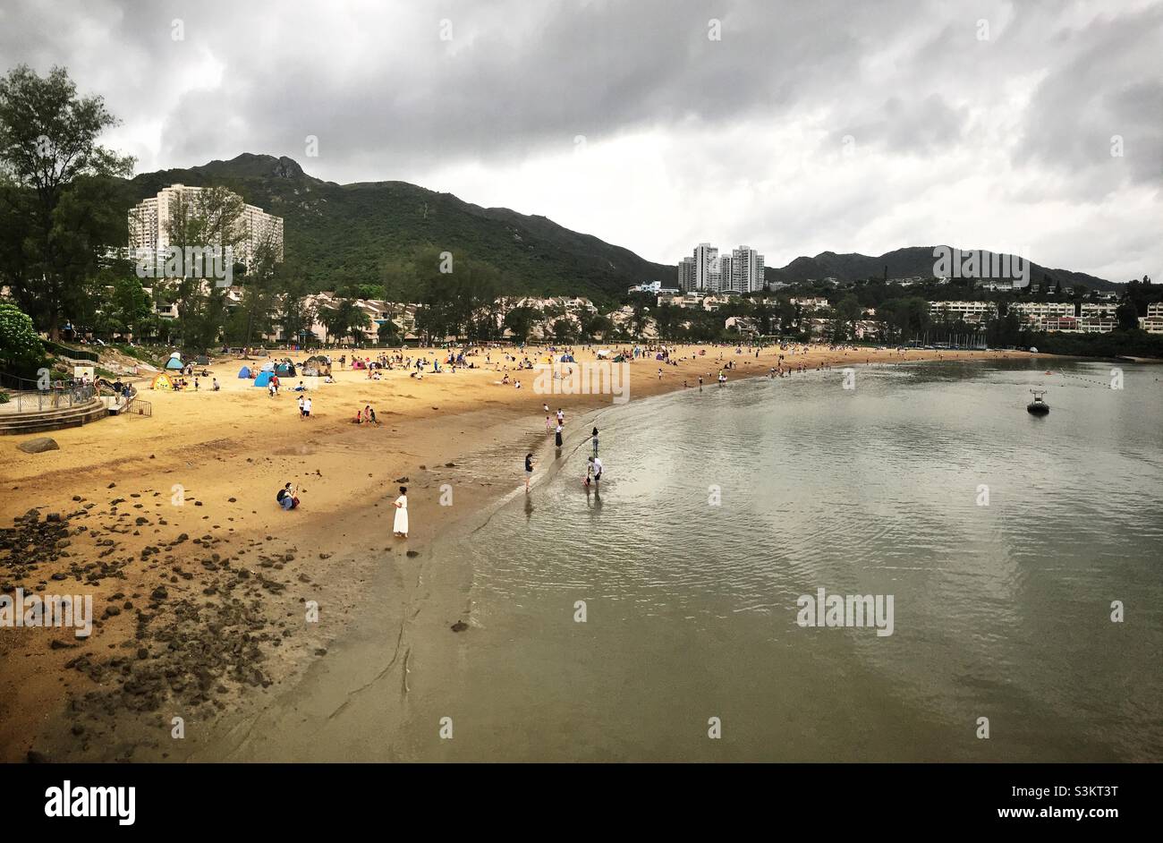 Domestic tourists visit Discovery Bay's man-made Tai Pak Beach, Lantau Island, Hong Kong Stock Photo