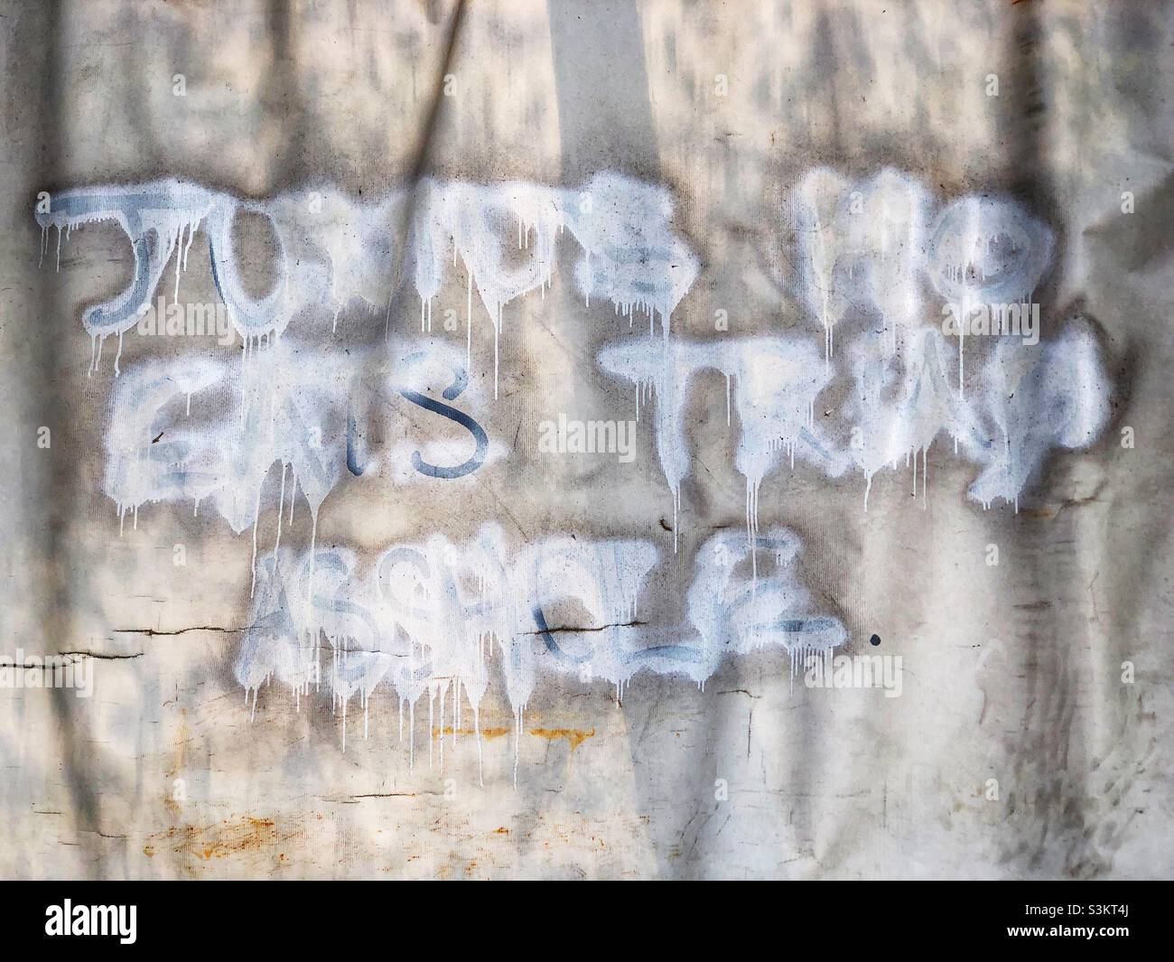 Ineffectively obscured graffiti insulting Junius Ho, a pro-Beijing Hong Kong Legislative Council member who was vocal and active in opposition to the 2019 anti-Extradition Bill protests, 2020 - Smartphone Captured Stock Image