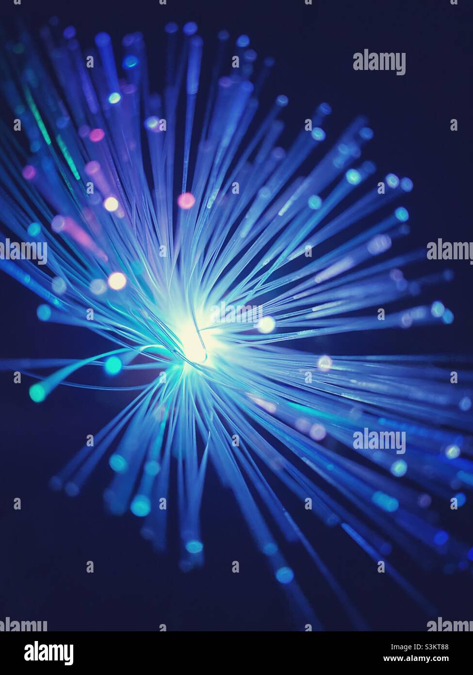A starburst effect photograph of a fibre optic lamp in pink purple and blue colours Stock Photo