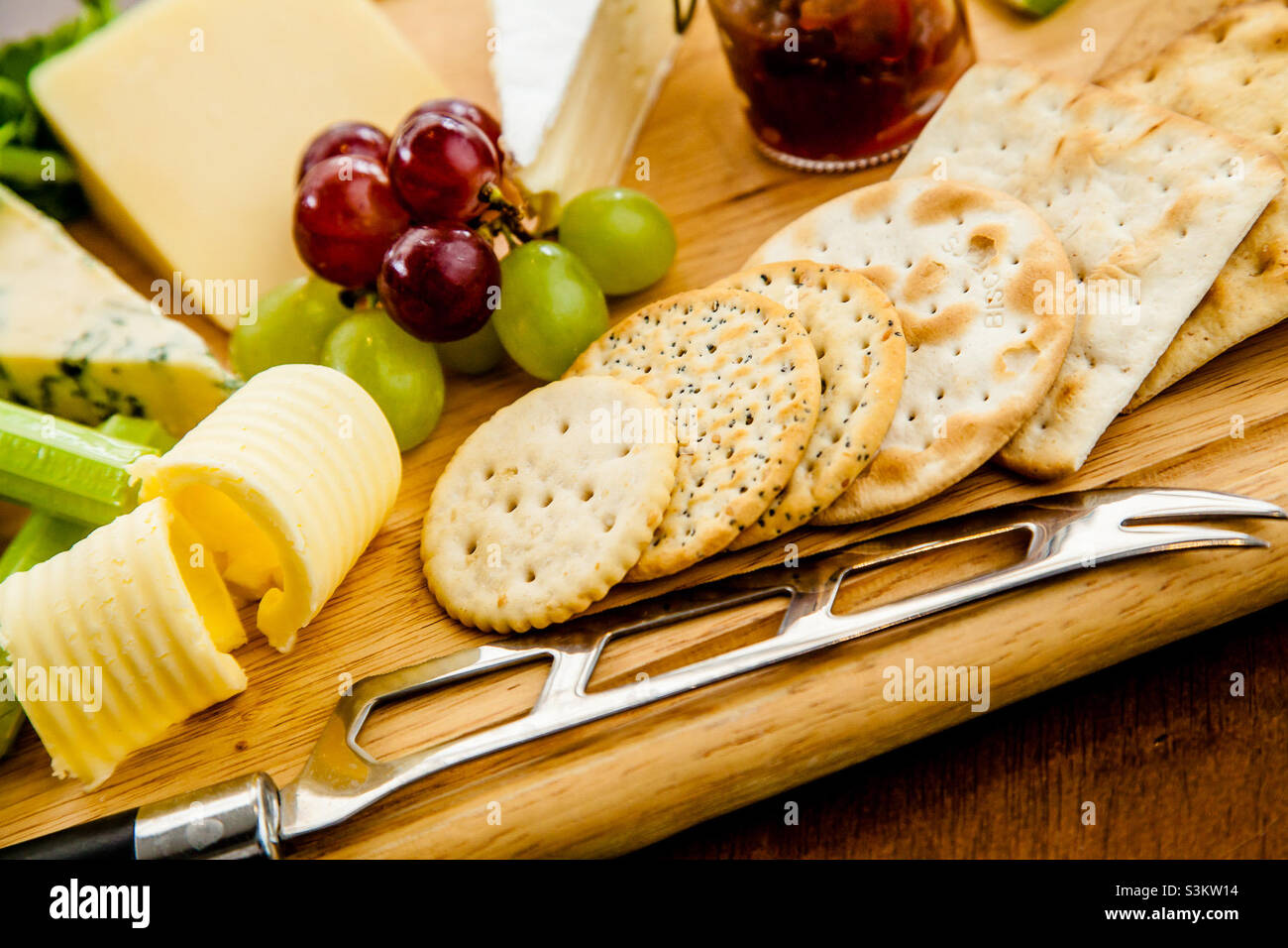 Cheese board with grapes and chutney Stock Photo Alamy