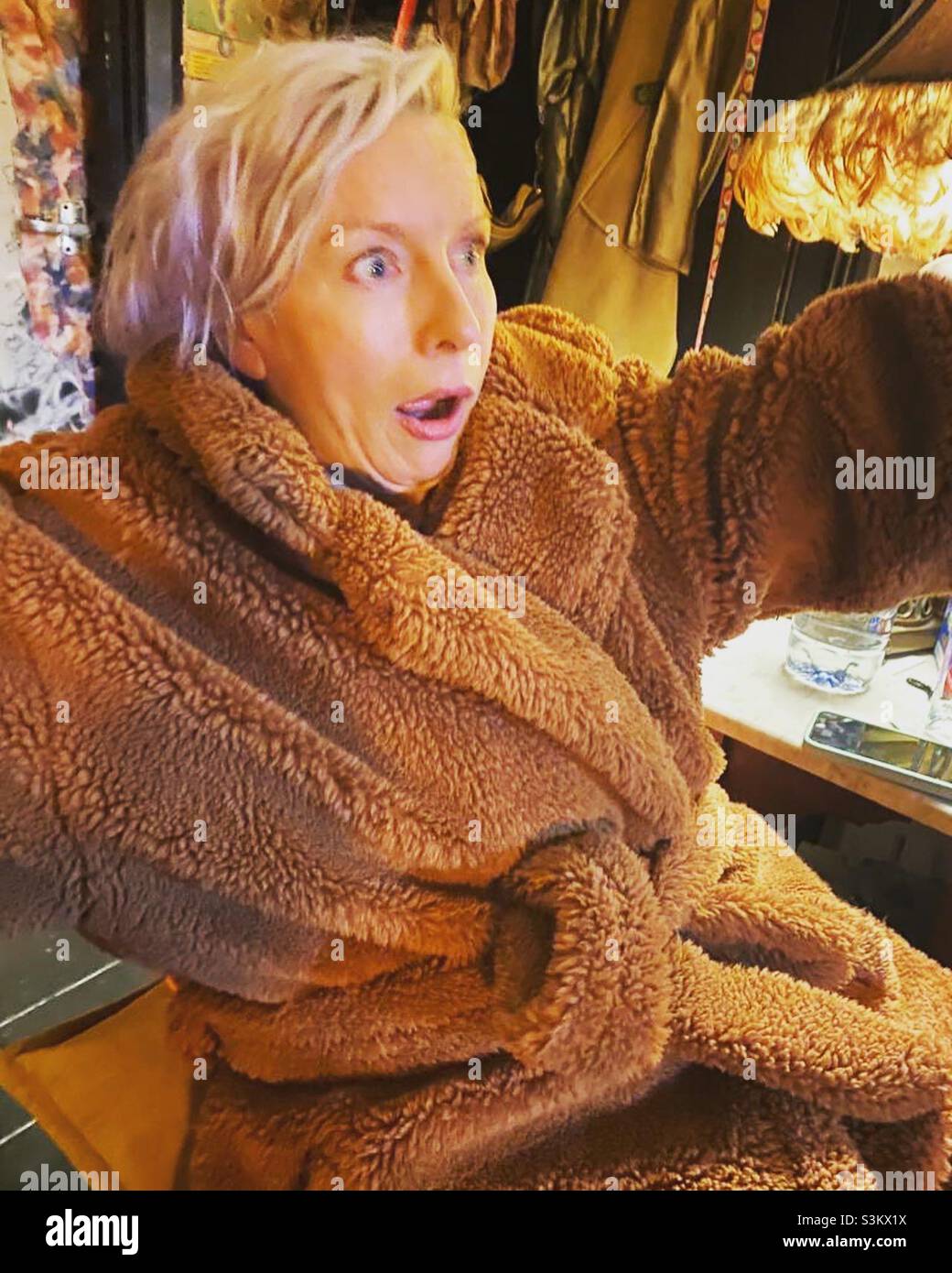 Woman looking shocked in furry coat - Smartphone Captured Stock Image