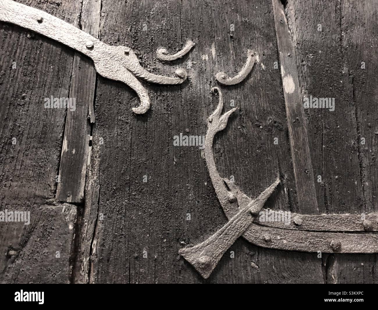 Part of the oldest door in the UK at Stillingfleet Church, near York with a unique depiction of a Viking long boat in iron strap work and a decorative dragon’s head. Stock Photo