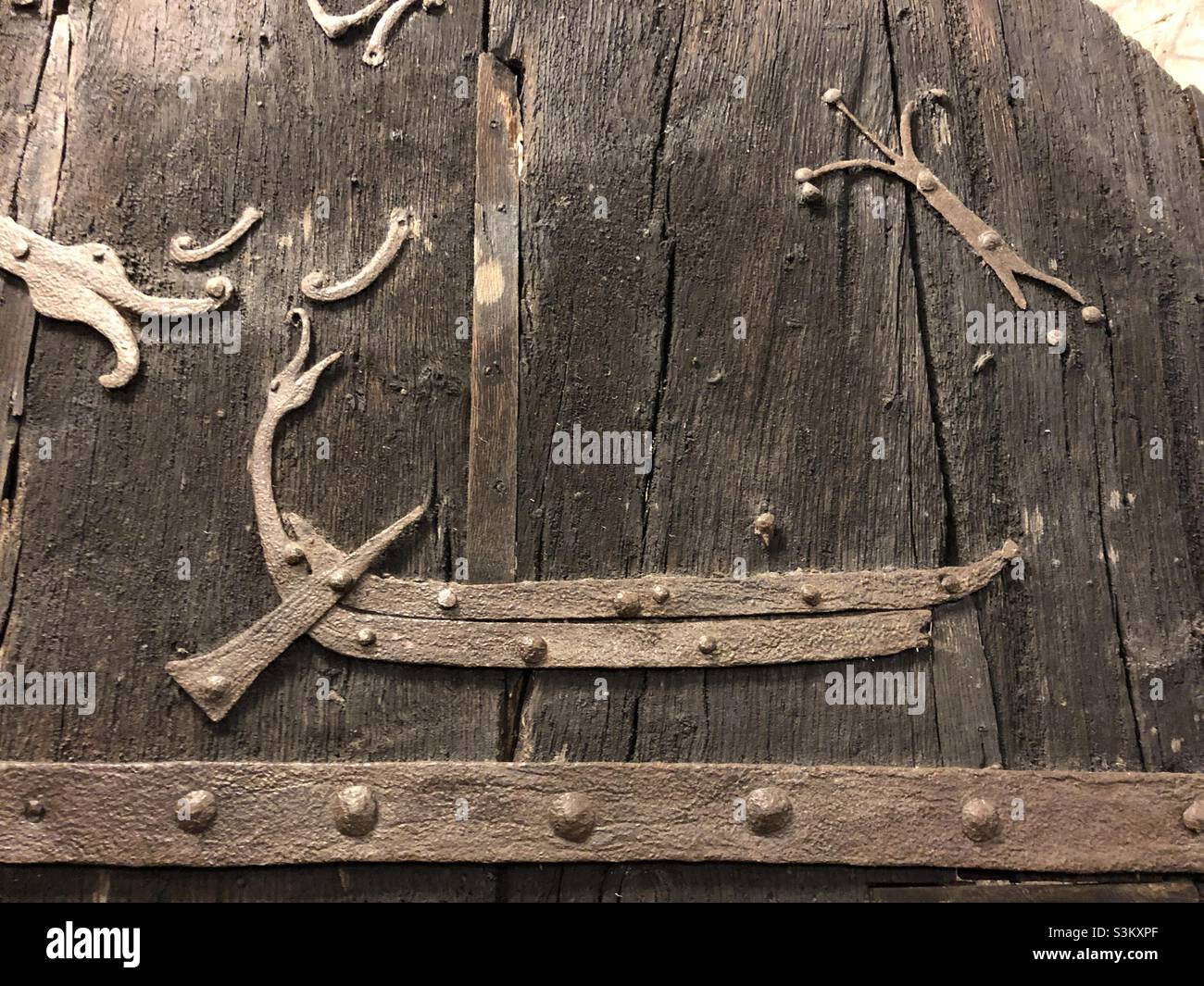 A Viking long boat depicted on the oldest door in the UK at Stillingfleet Church as well as a Dragon’s head. Stock Photo