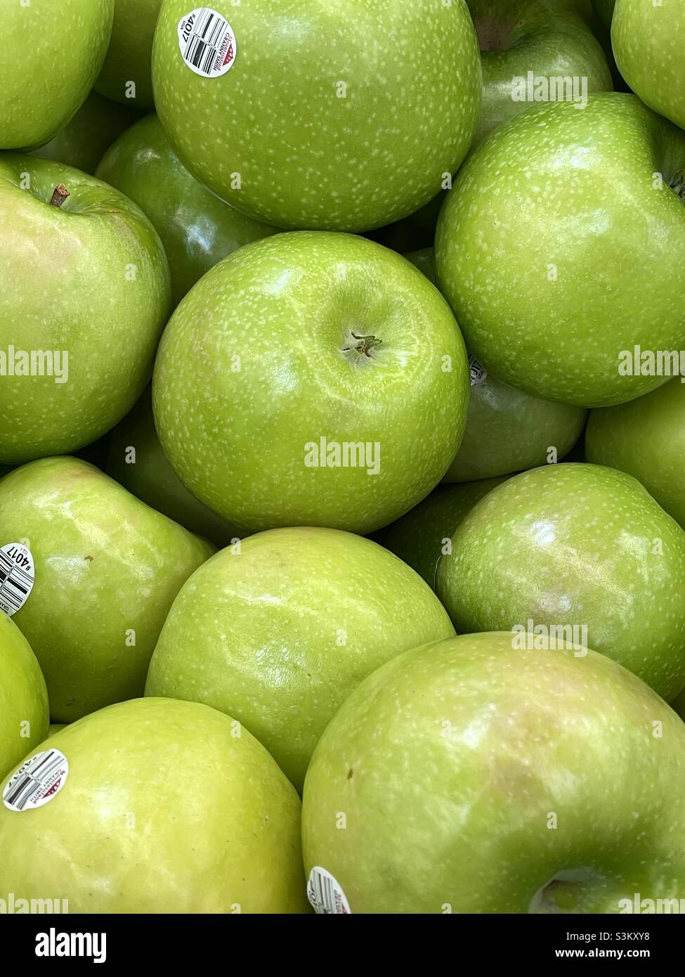 Close shot of fresh green apples for sale in the produce department of a local Walmart in Utah, USA. - Smartphone Captured Stock Image