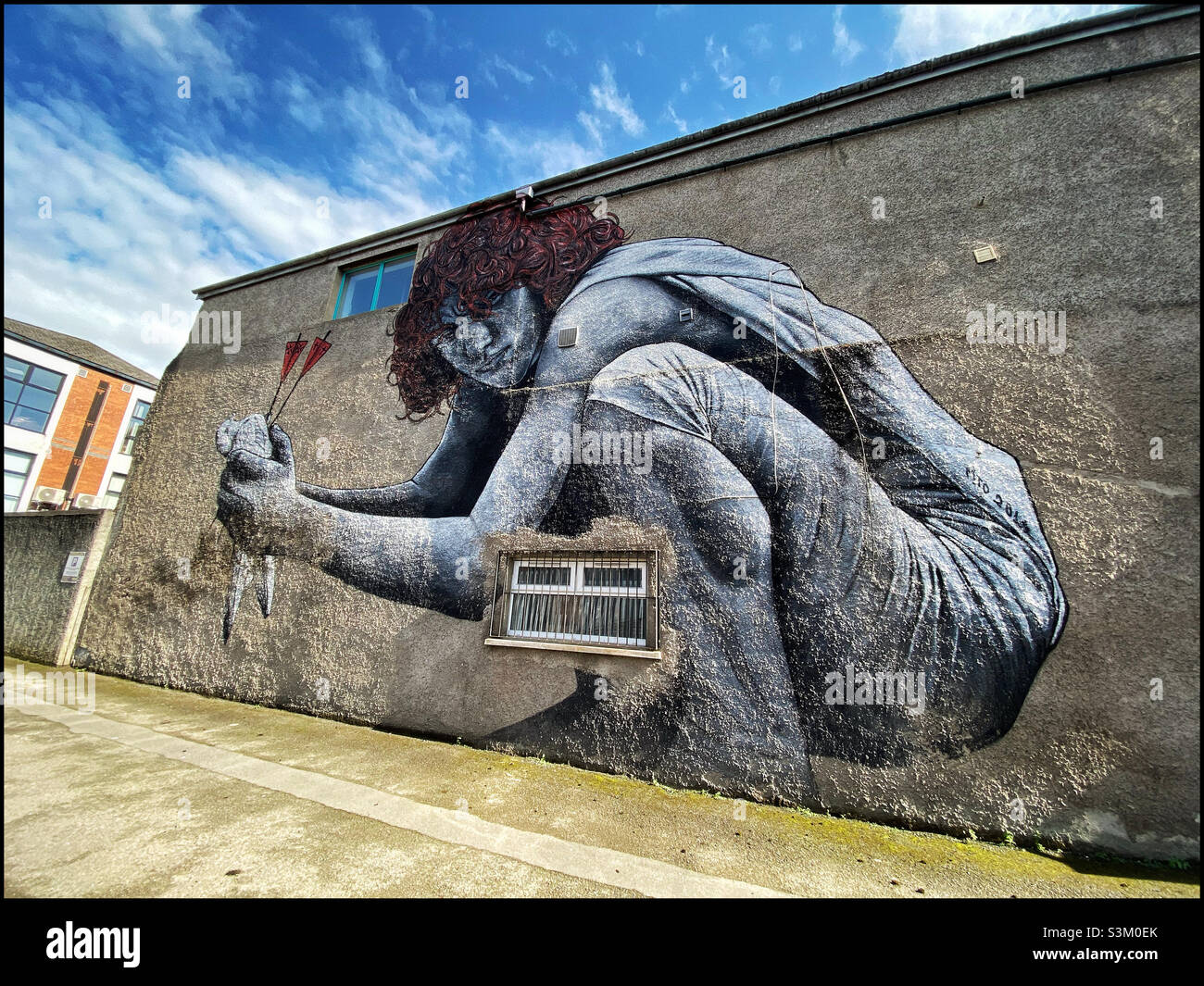 “The Son of Protagoras.” An impressive piece of artwork painted on the side of a Belfast building. A comment on The Troubles & religion being the cause of problems. Photo ©️ COLIN HOSKINS. - Smartphone Captured Stock Image