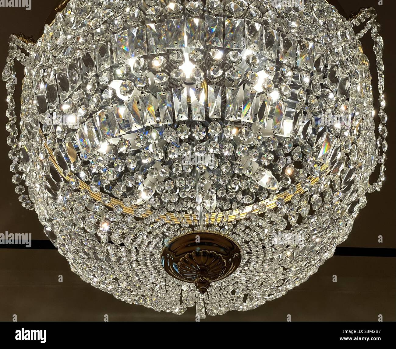 A crystal chandelier hanging inside the Grand America hotel in Salt Lake City, Utah, USA. - Smartphone Captured Stock Image