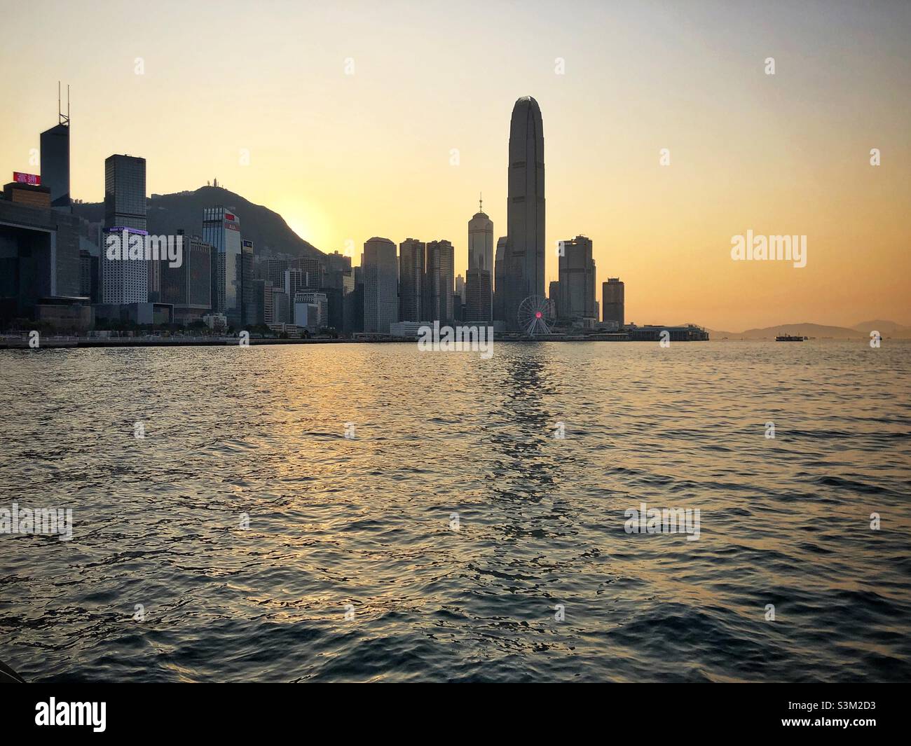 2ifc (2 International Finance Centre), a skyscraper in Central and Hong Kong's second tallest building, the Hong Kong Island skyline and Victoria Harbour, at sunset - Smartphone Captured Stock Image