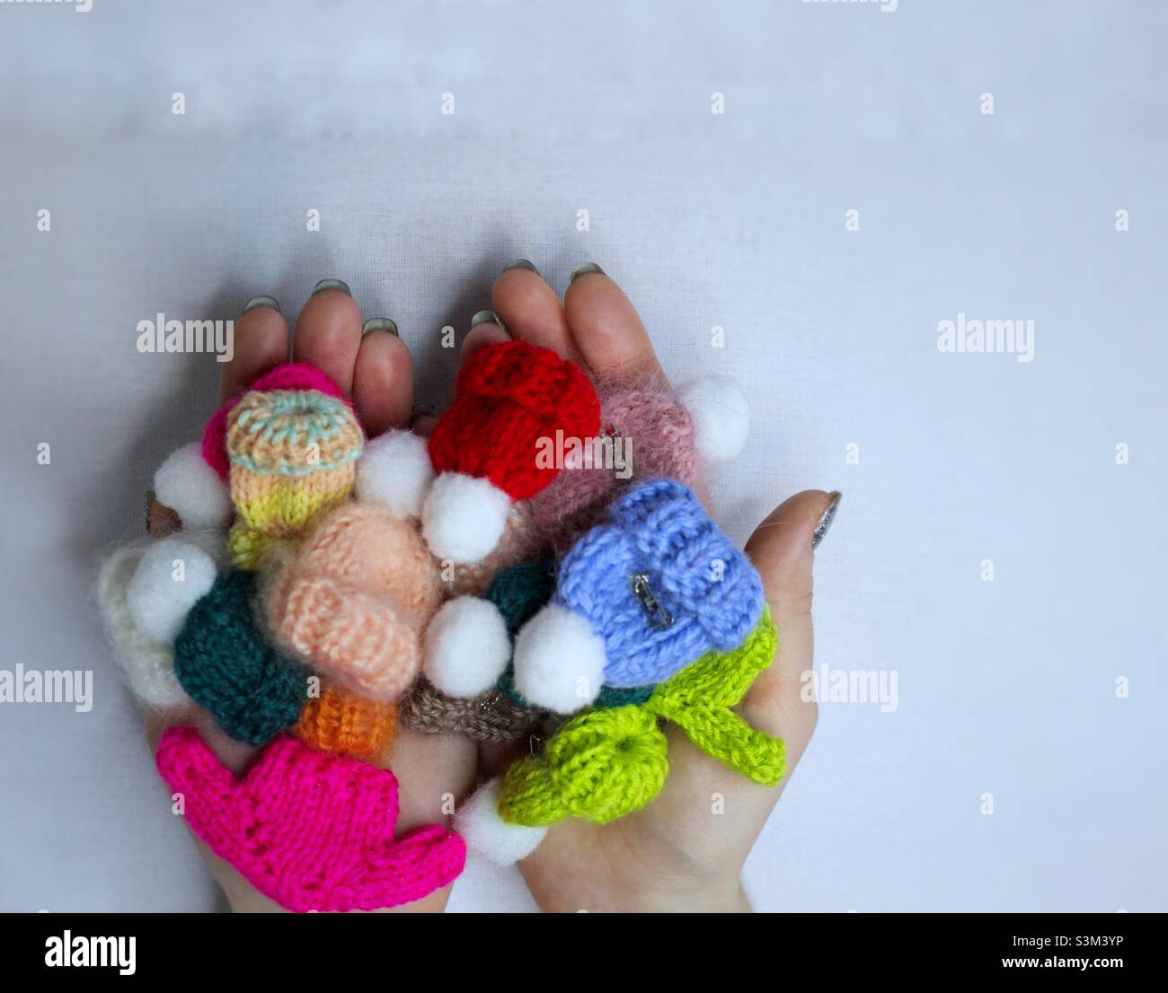 Multicolored brooches in the hands - Smartphone Captured Stock Image