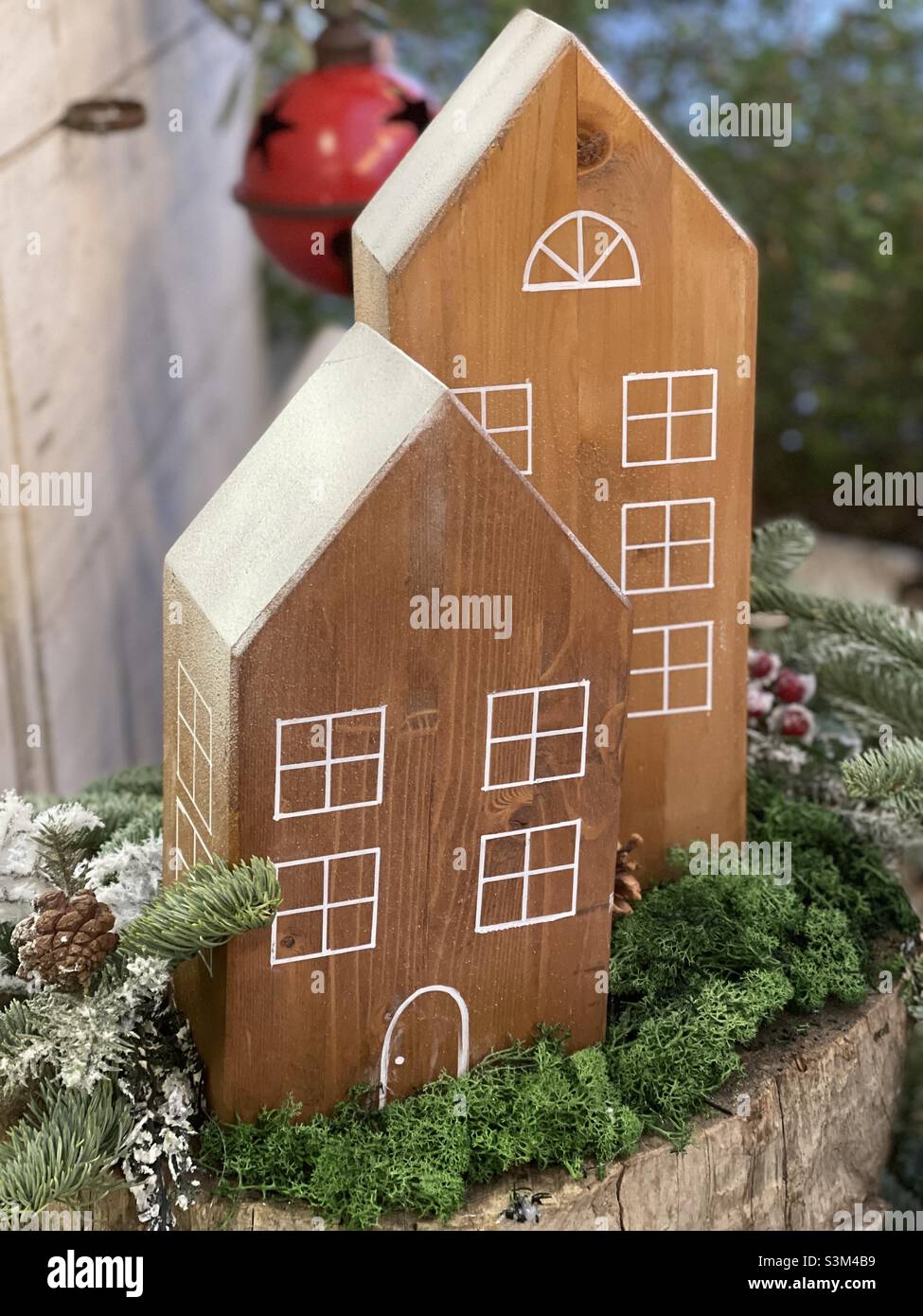 Christmas tine with wooden house art work - Smartphone Captured Stock Image