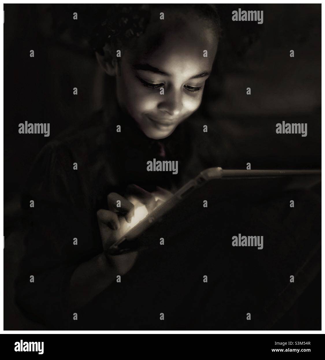 Young mixed race female studying at a computer. OU2021 - Smartphone Captured Stock Image