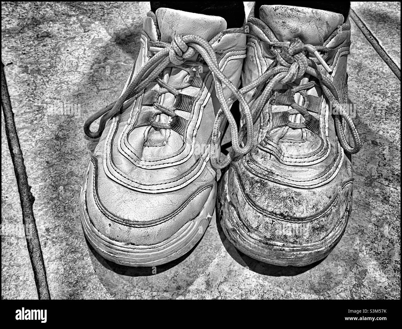 Right shoe - clean. Left shoe - dirty! A bit of a contraction? Strange? An interesting concept? Why? How come?! Photo ©️ COLIN HOSKINS. - Smartphone Captured Stock Image