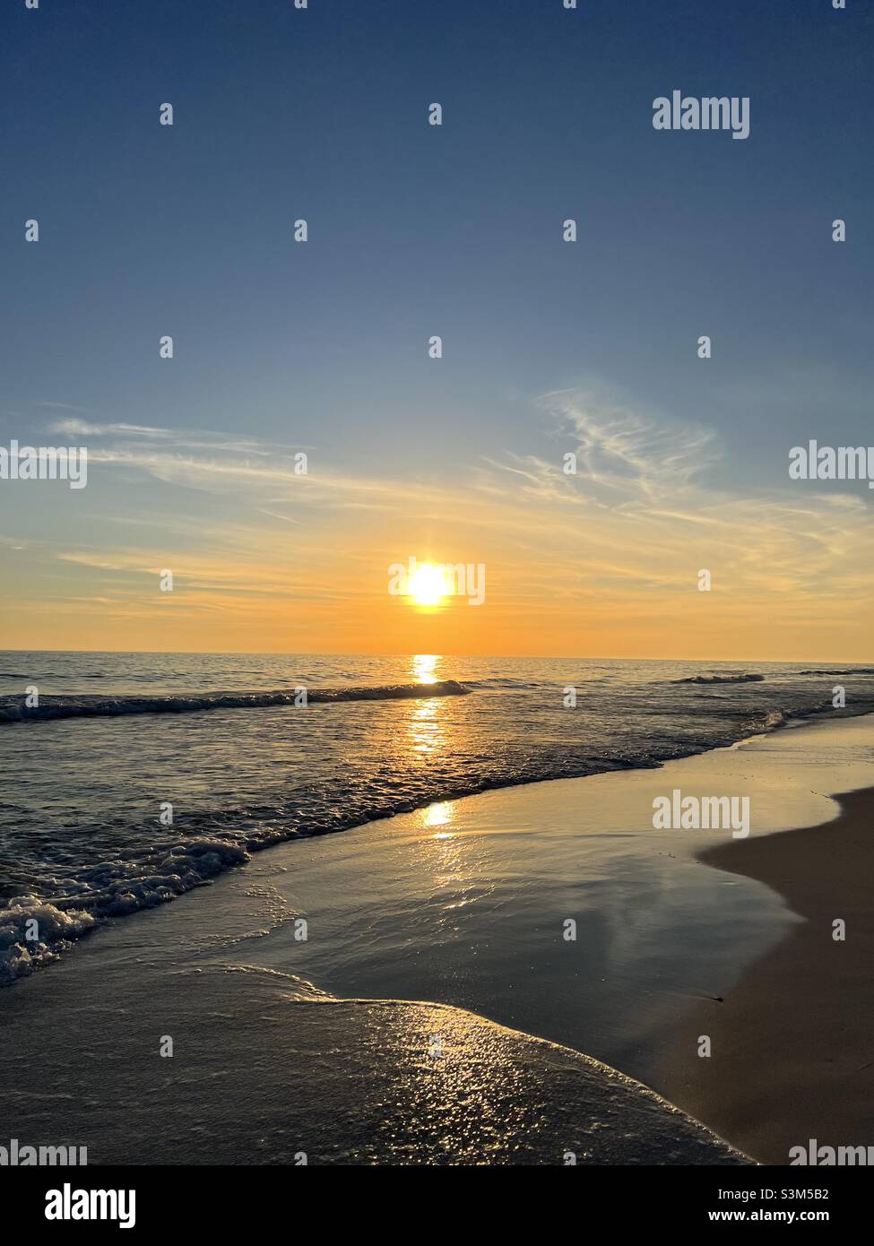 Golden sunset over the Gulf of Mexico water Destin Florida - Smartphone Captured Stock Image