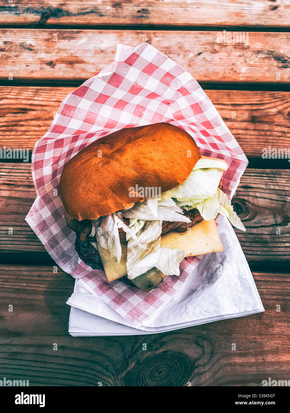 Take away beef burger with bacon, cheese and lettuce - Smartphone Captured Stock Image