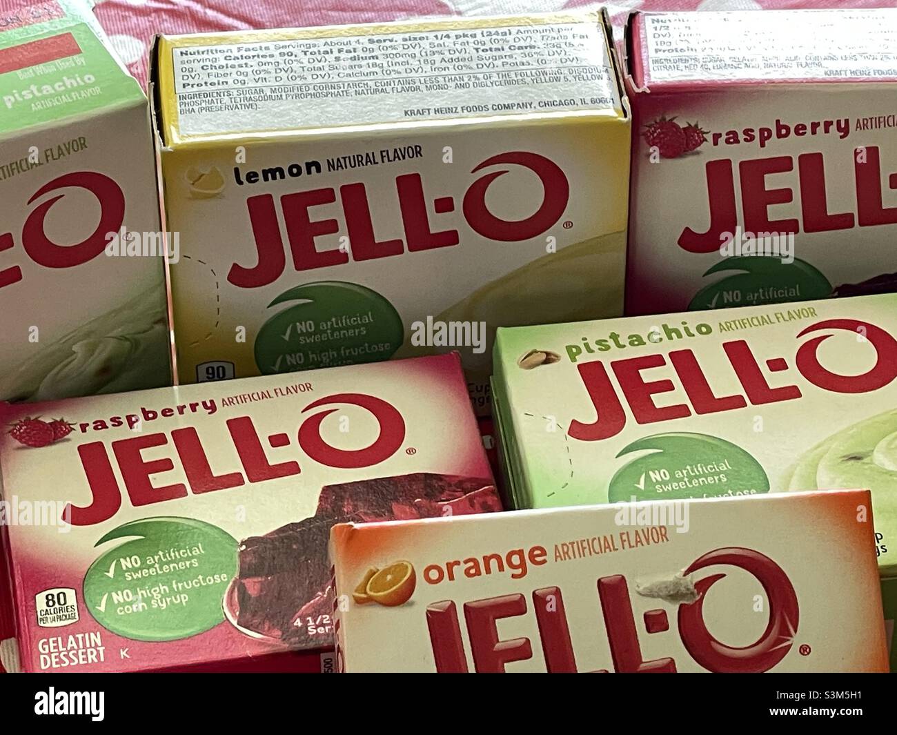 A still life of boxes of jell-o mixes of multiple flavors: raspberry, orange, lemon and pistachio. Stock Photo