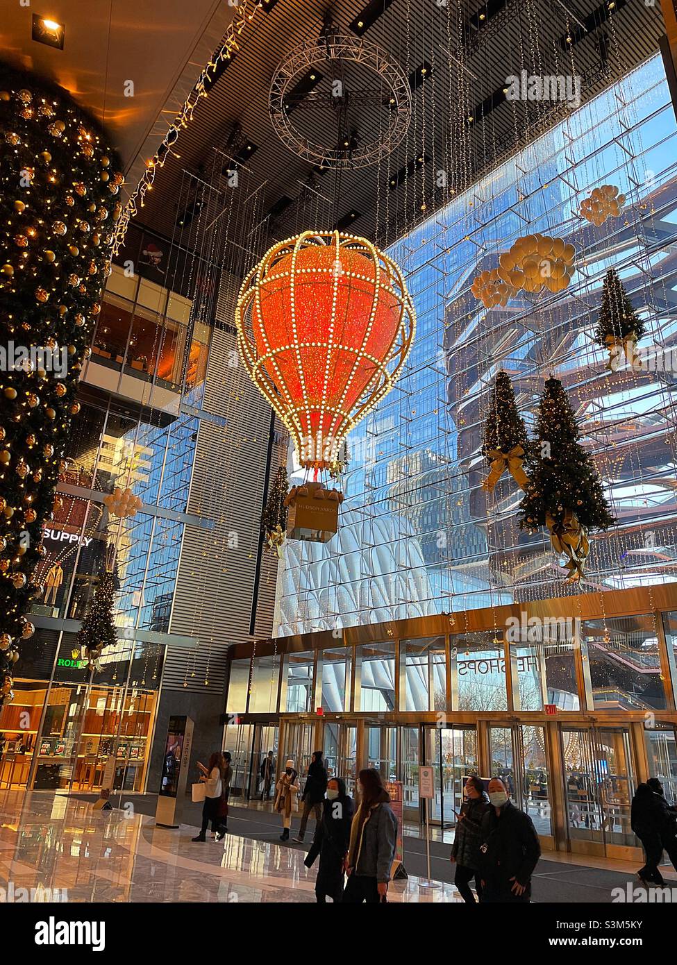 The entrance to the shops at Hudson yards features brightly lit hot air balloon lights as part of the shine bright light display sponsored by Wells Fargo bank, 2021, New York City, United States - Smartphone Captured Stock Image