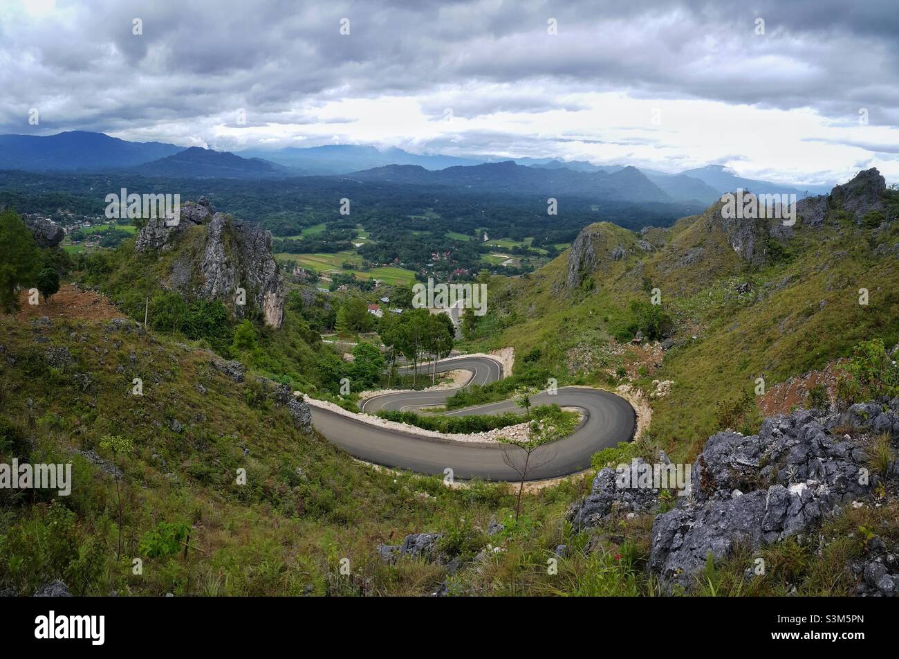 The winding roads of Burake hills where stand the statue of Jesus Christ Blesing at Makale in Tana Toraja Regency, South Sulawesi, Indonesia. Stock Photo
