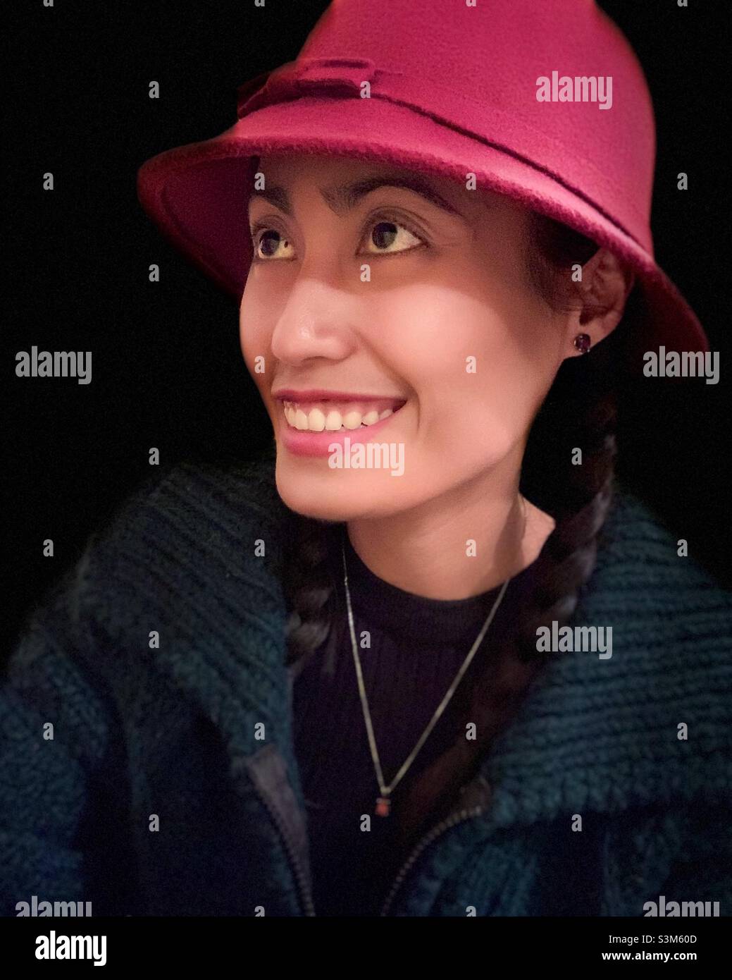 Portrait of a woman smiling and looking up. - Smartphone Captured Stock Image