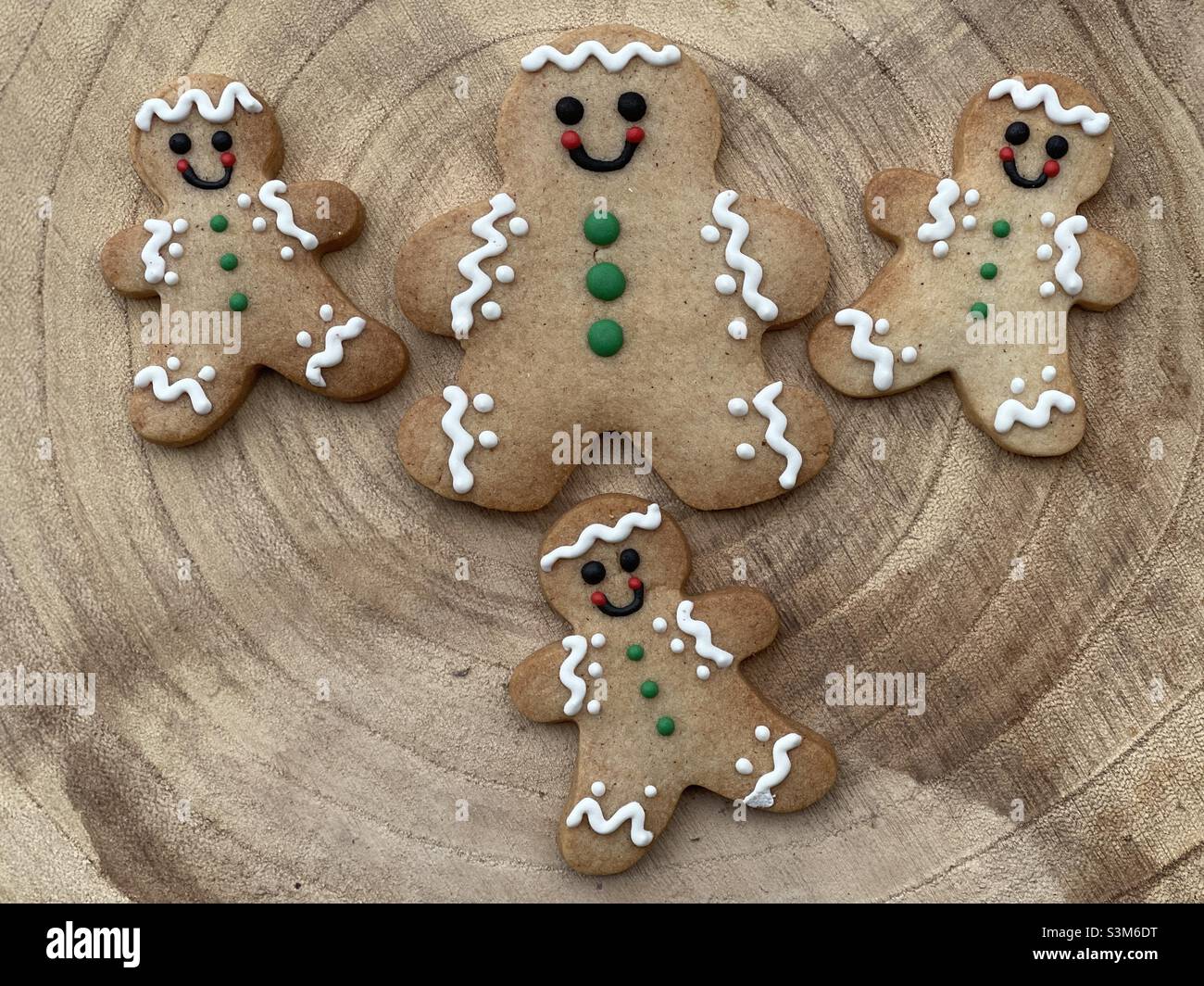 Many gingerbread on a wooden board for a Merry Christmas to you all Stock Photo