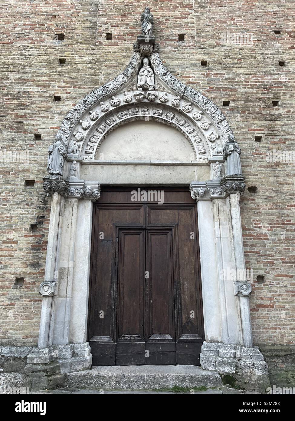 View over the beautiful portal of the church of Saint Agostino made by Matteo Capro, known as Matteo da Napoli, Atri, Abruzzo, Italy - Smartphone Captured Stock Image