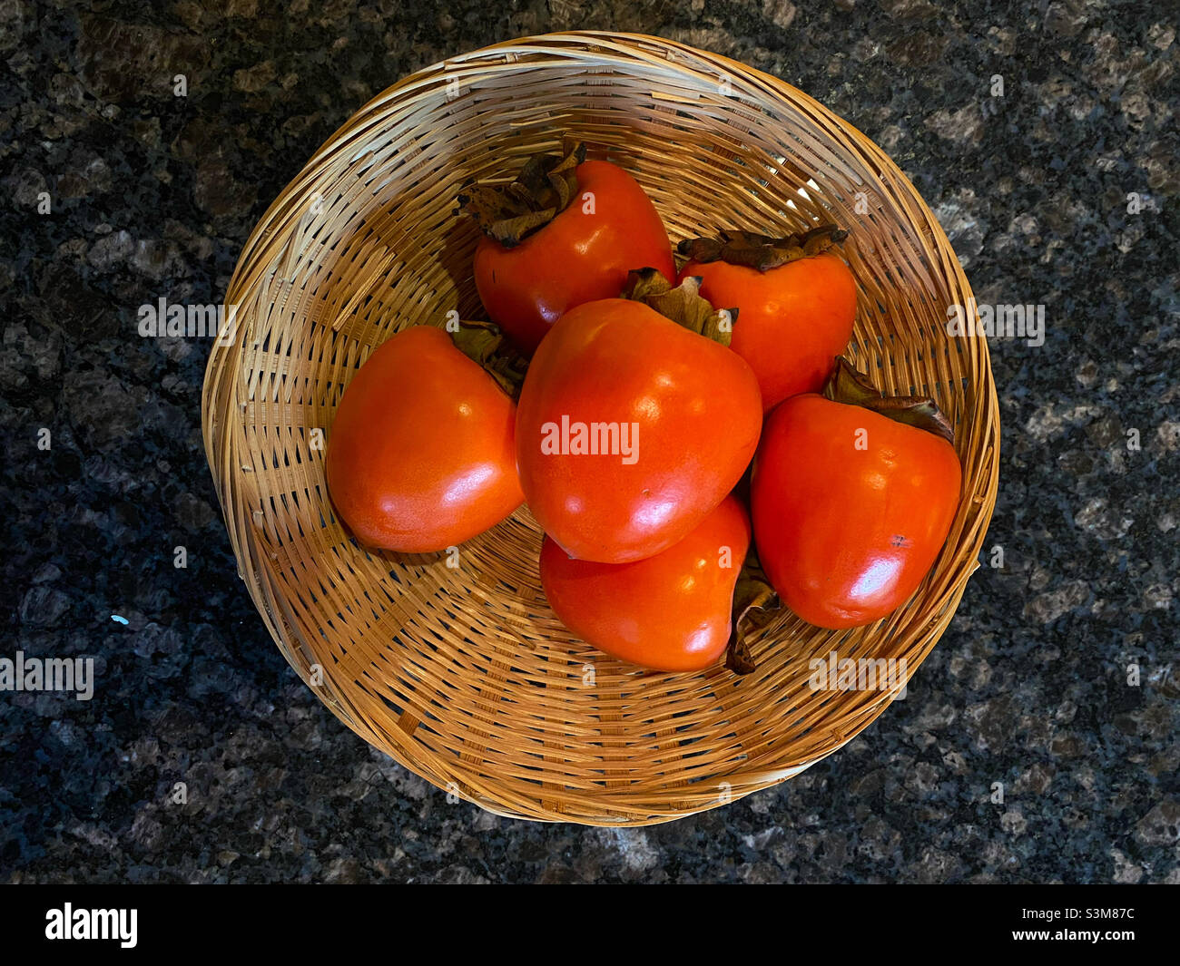 Ripe persimmons in a basket - Smartphone Captured Stock Image