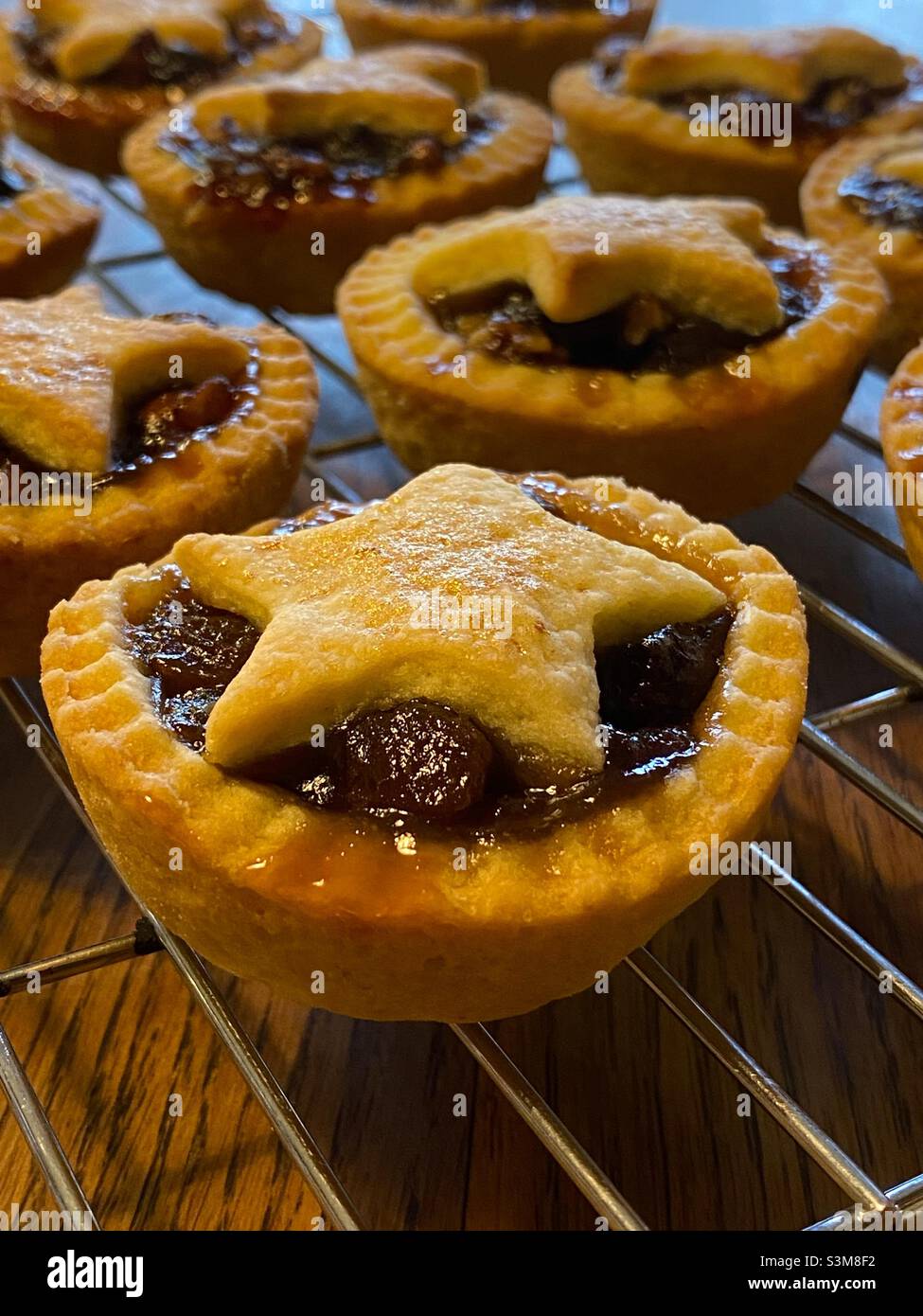 Freshly baked mince pies on a cooling rack Stock Photo