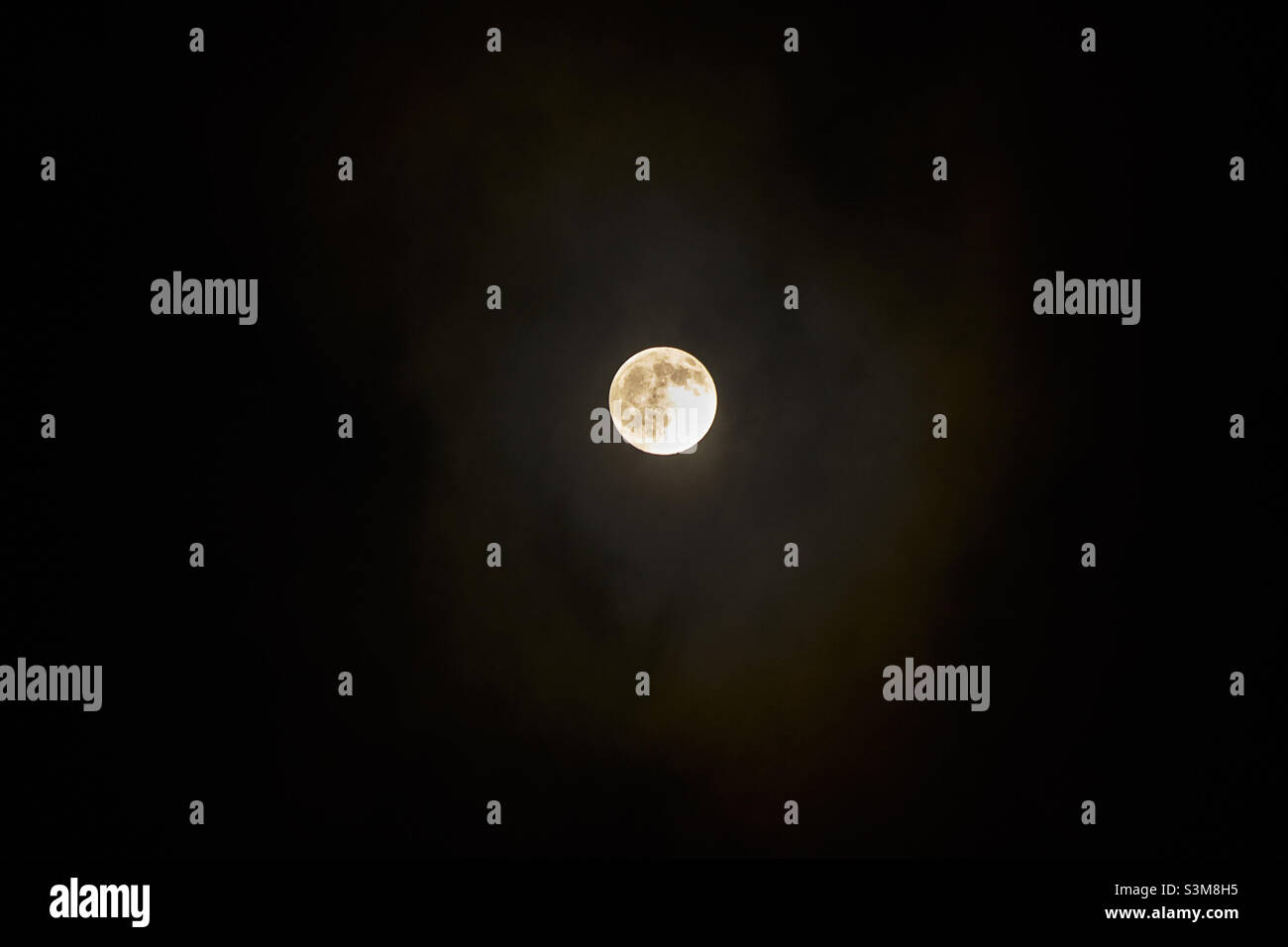 Full moon behind clouds Stock Photo Alamy