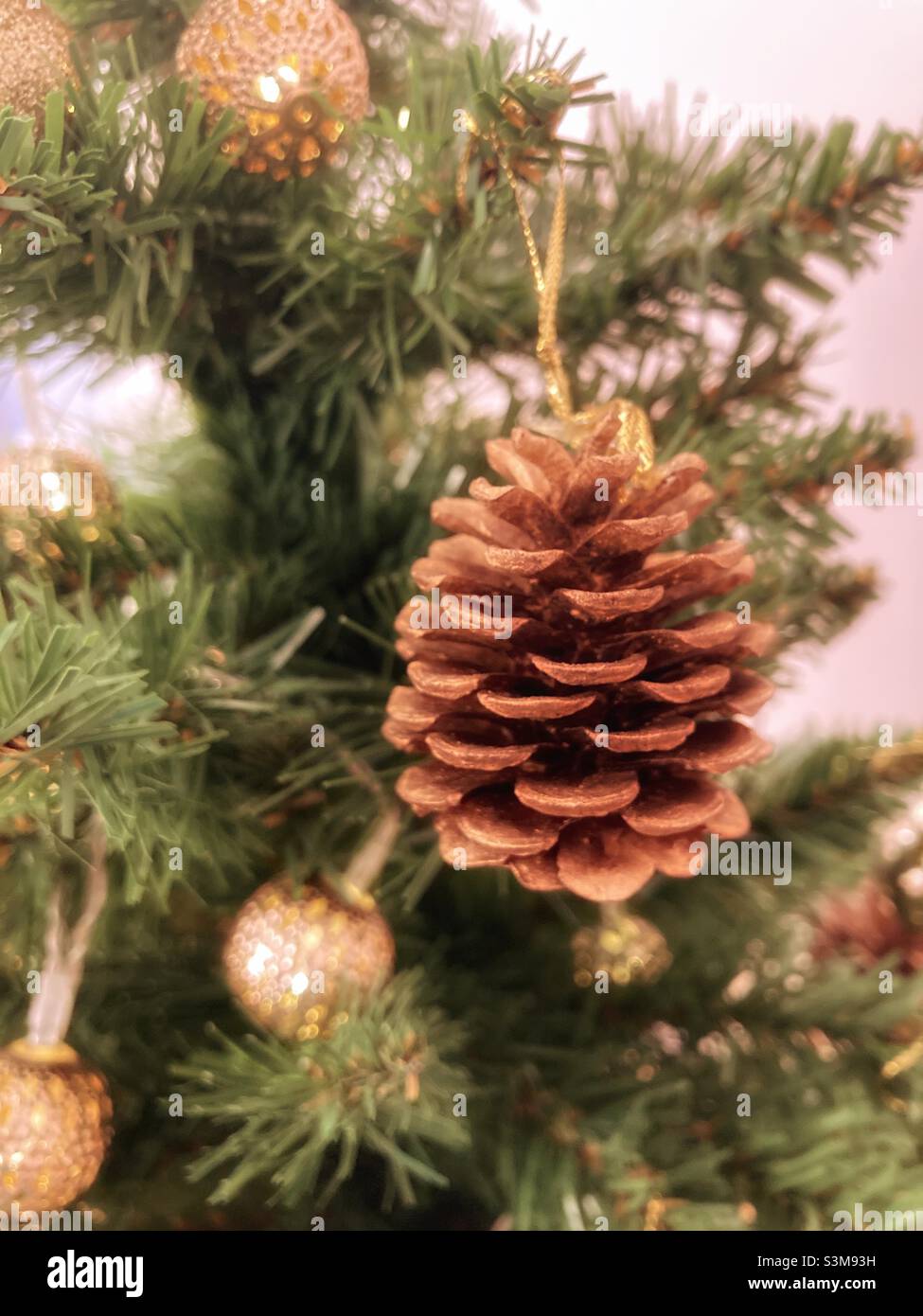 A fir cone hanging on a Christmas tree. - Smartphone Captured Stock Image