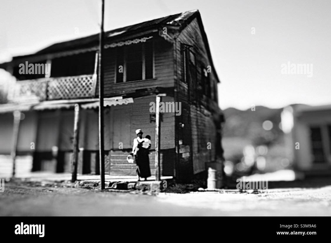 Mother and child outside ramshackle building in rural Jamaica. - Smartphone Captured Stock Image
