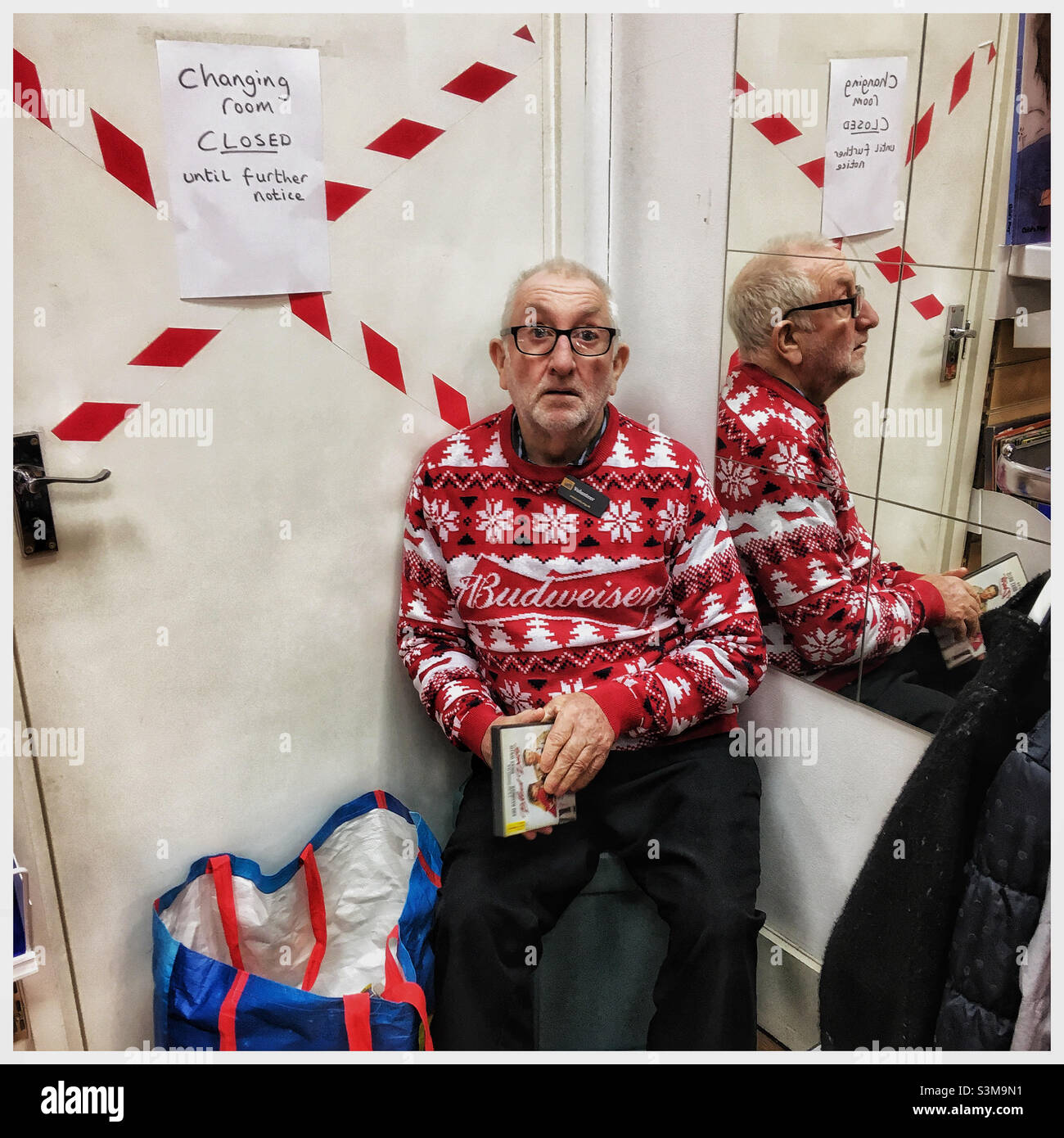 Charity shop volunteer in Budweiser jumper - Smartphone Captured Stock Image