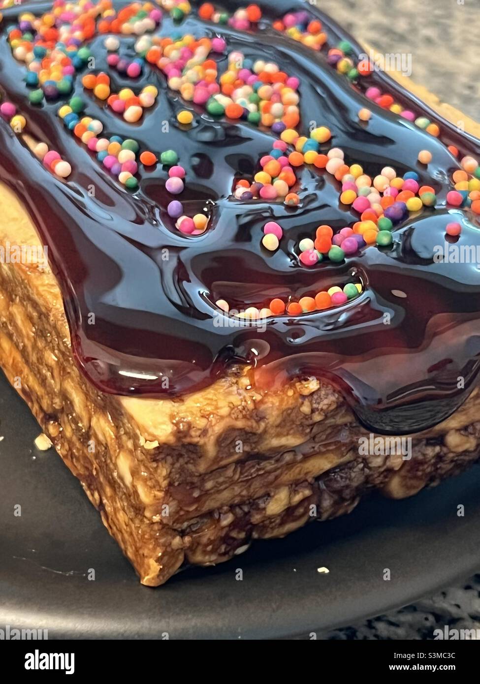 Turrón de Doña Pepa, sweet, cookie layered anise flavored treat soaked in brown sugar cane syrup (called chancaca) and topped with candy sprinkles. Stock Photo