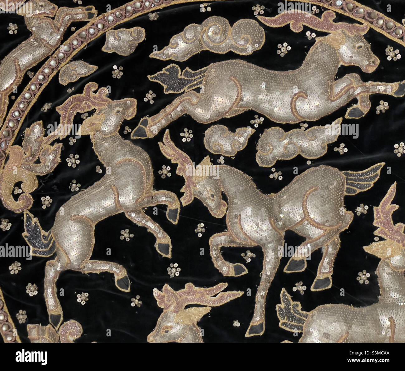 A piece of embroidery from Thailand on black velvet Padded and studied with sequins - Smartphone Captured Stock Image