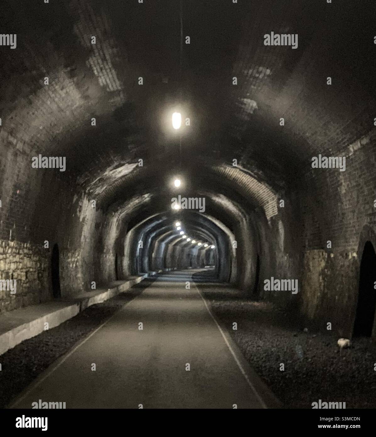 Headstone Tunnel, Monsal Trail, Derbyshire, Dec 2021. Lit from dawn to dusk allowing safe passage for walkers and cyclists. One of several underground, now disused steam train tunnels near Bakewell. Stock Photo