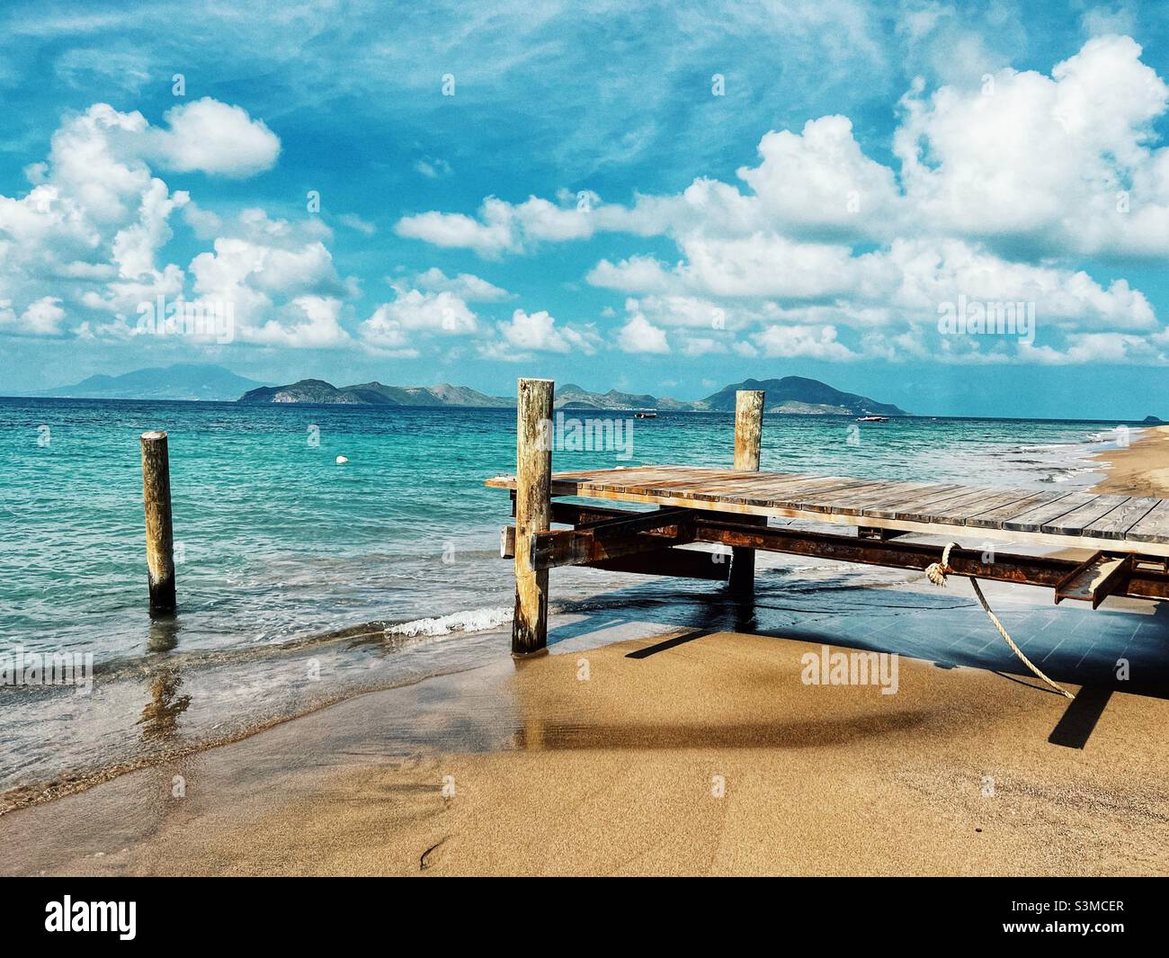 Beach on Nevis with view of St.Kitts in the distance Stock Photo - Alamy