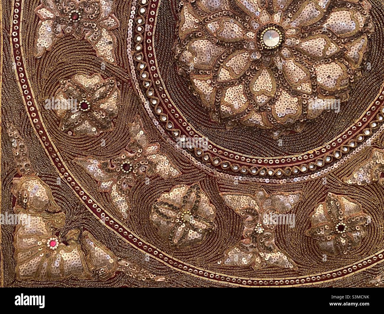 A detail from a Burmese Tapestry with Rich needlework in gold and started with sequins - Smartphone Captured Stock Image