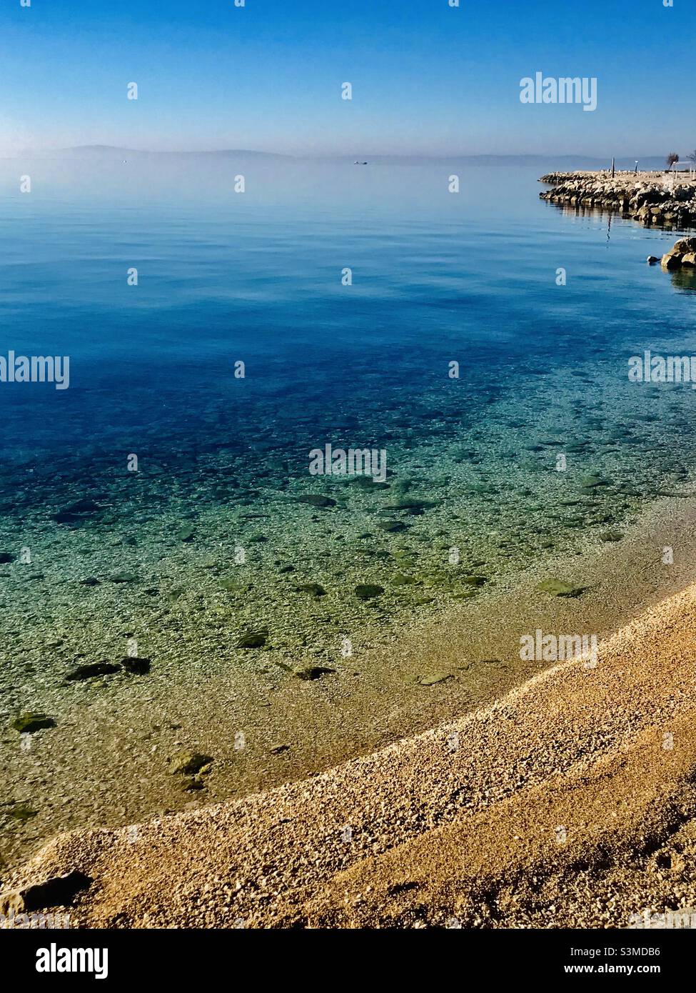 A crystal clear sea at the Znjan beach in the Adriatic port of Split, Croatia - Smartphone Captured Stock Image