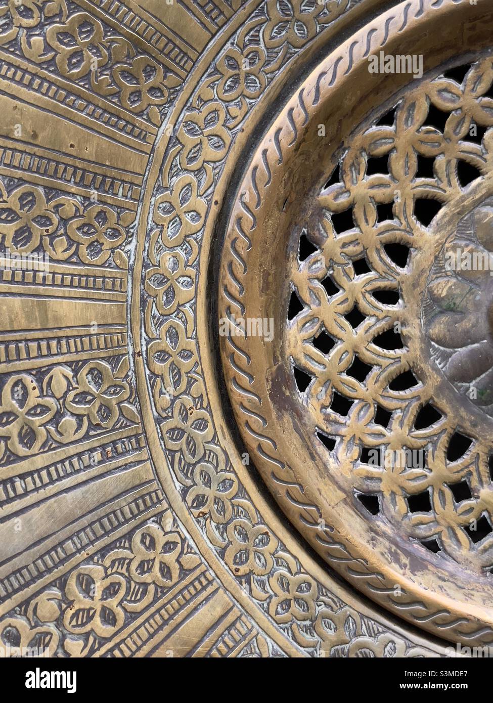 A detail of a middle eastern piece of brassware, possibly an incense burner - Smartphone Captured Stock Image