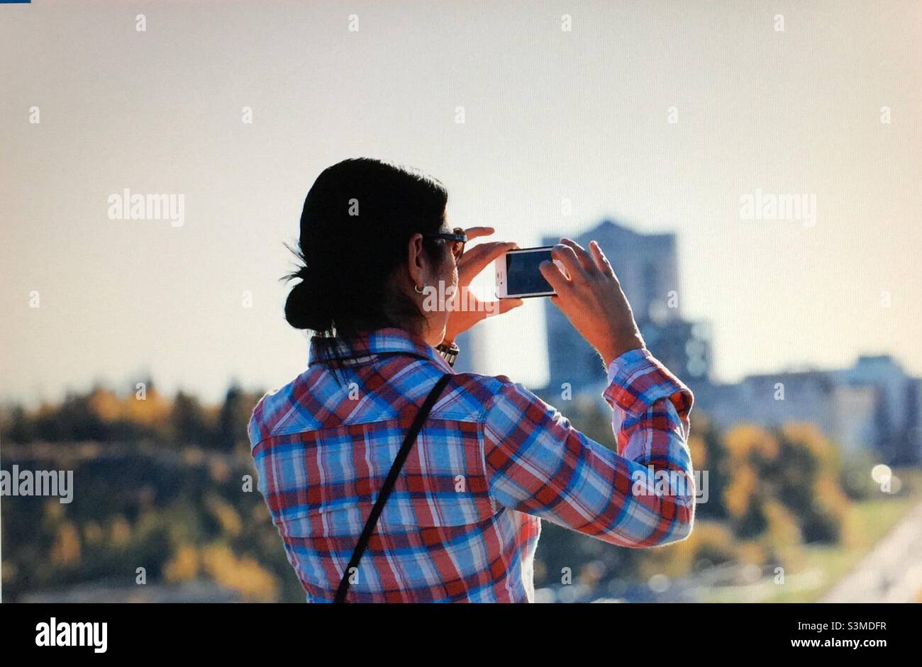 Woman, photographer, photographing, Yellowknife, Northwest Territories, Canada - Smartphone Captured Stock Image