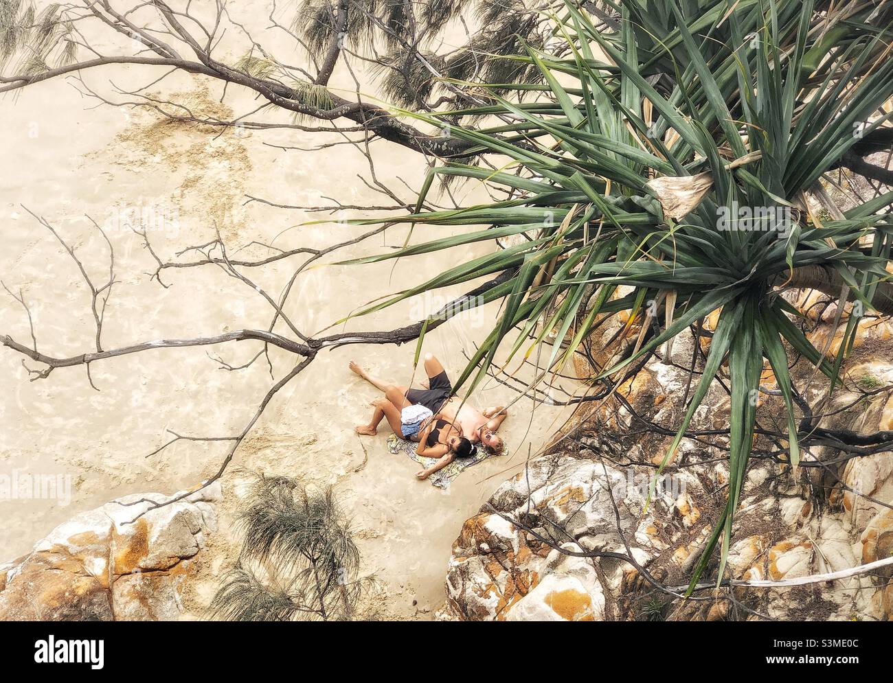 Couple relaxing on beach Coolum Beach  Queensland Australia - Smartphone Captured Stock Image
