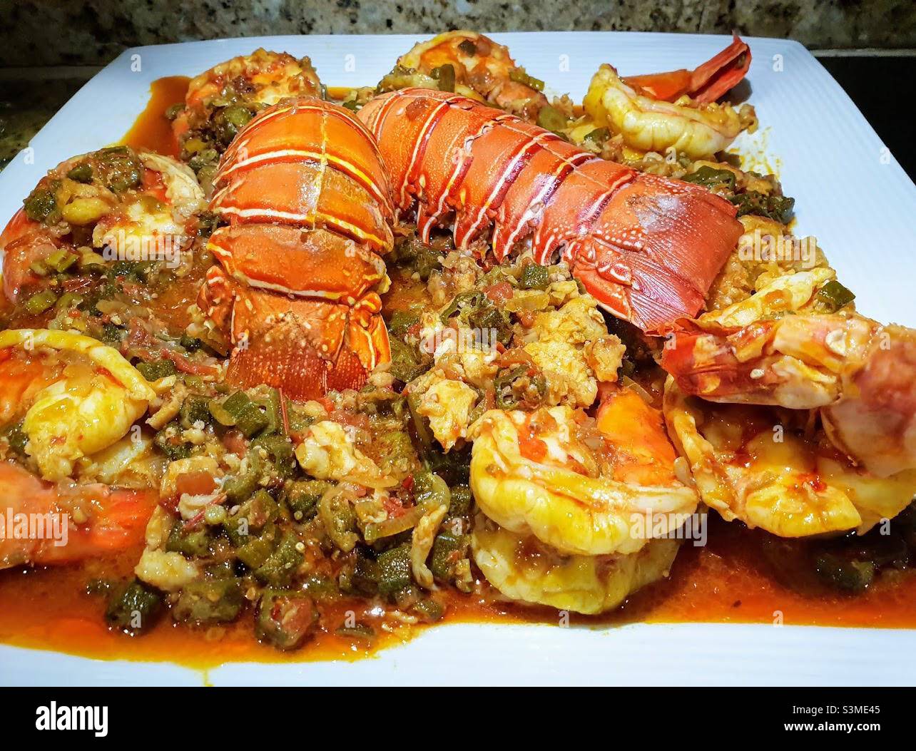 Seafood okro stew with prawns and lobster, Ghanaian food Stock Photo