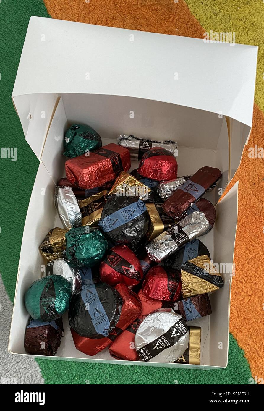 Present of colourful locally-made handmade chocolate delights for a Greek family on Christmas Day. Children delighted in picking their favourite colours and shapes. Stock Photo