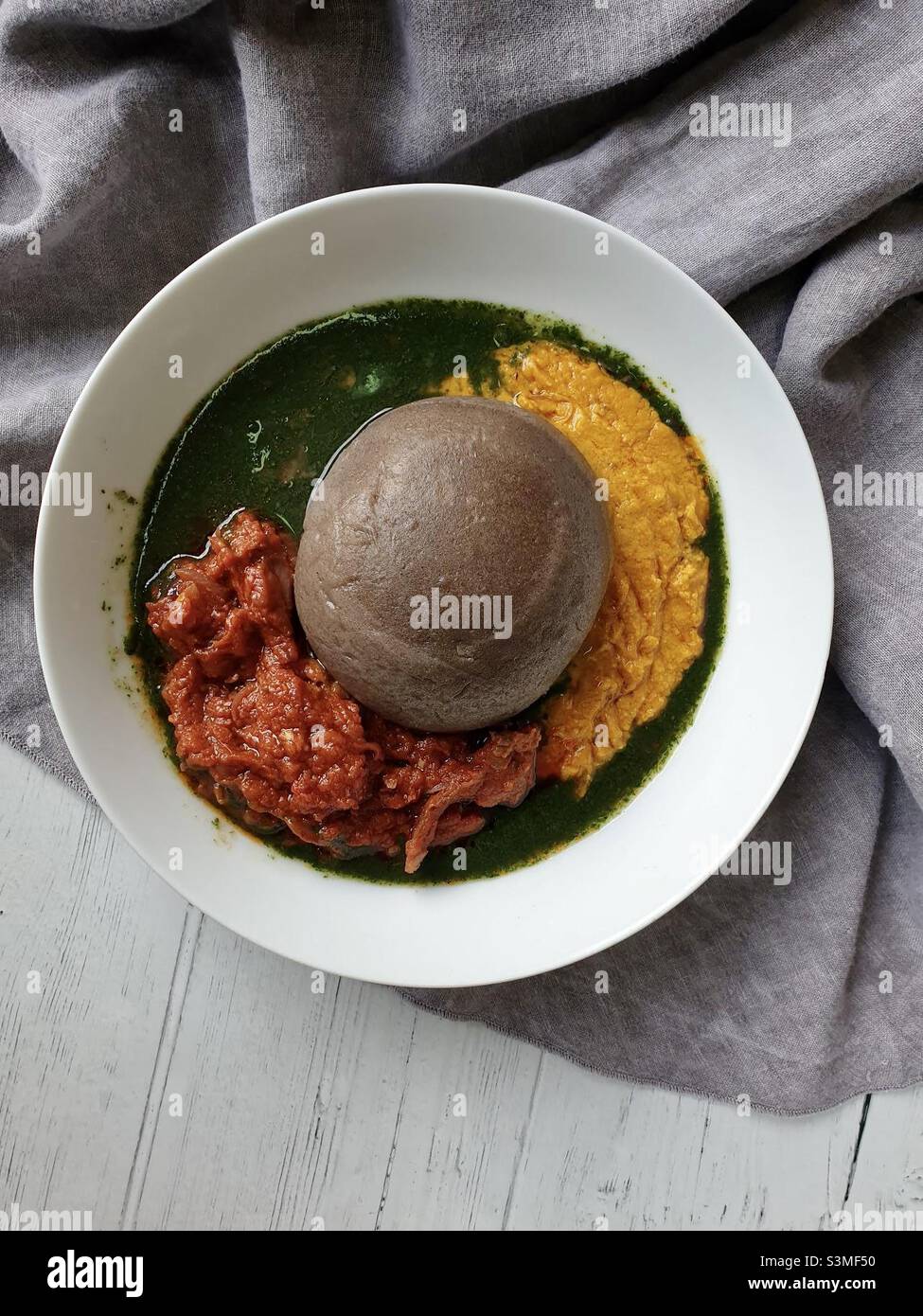 Amala, a dried yam paste dumpling, and abula. Abula is a trio of sauces